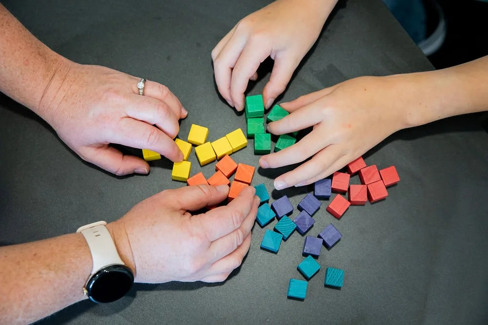 A child and therapist playing with colourful blocks during a child counselling session at Core Psychology in Calgary