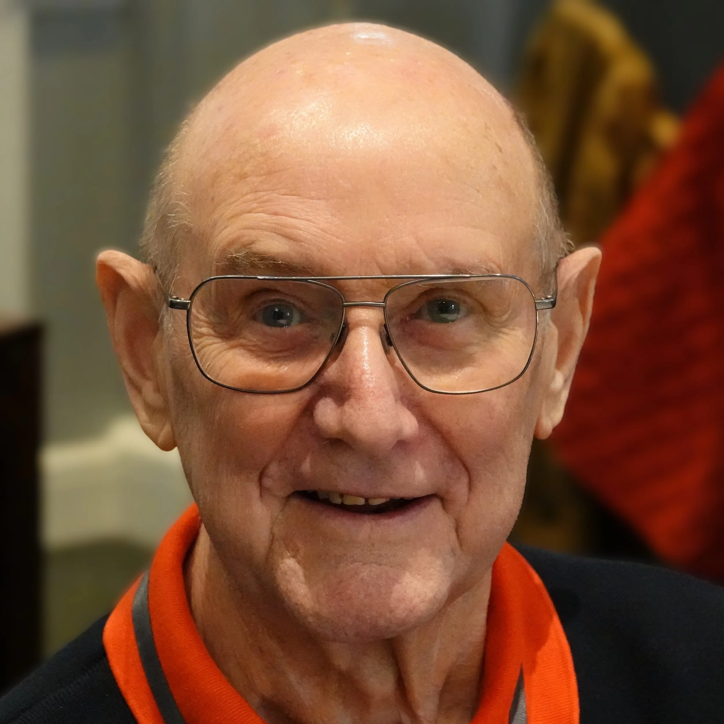 Close-up of a  man with glasses, smiling, at a Speakability meeting in Newbury