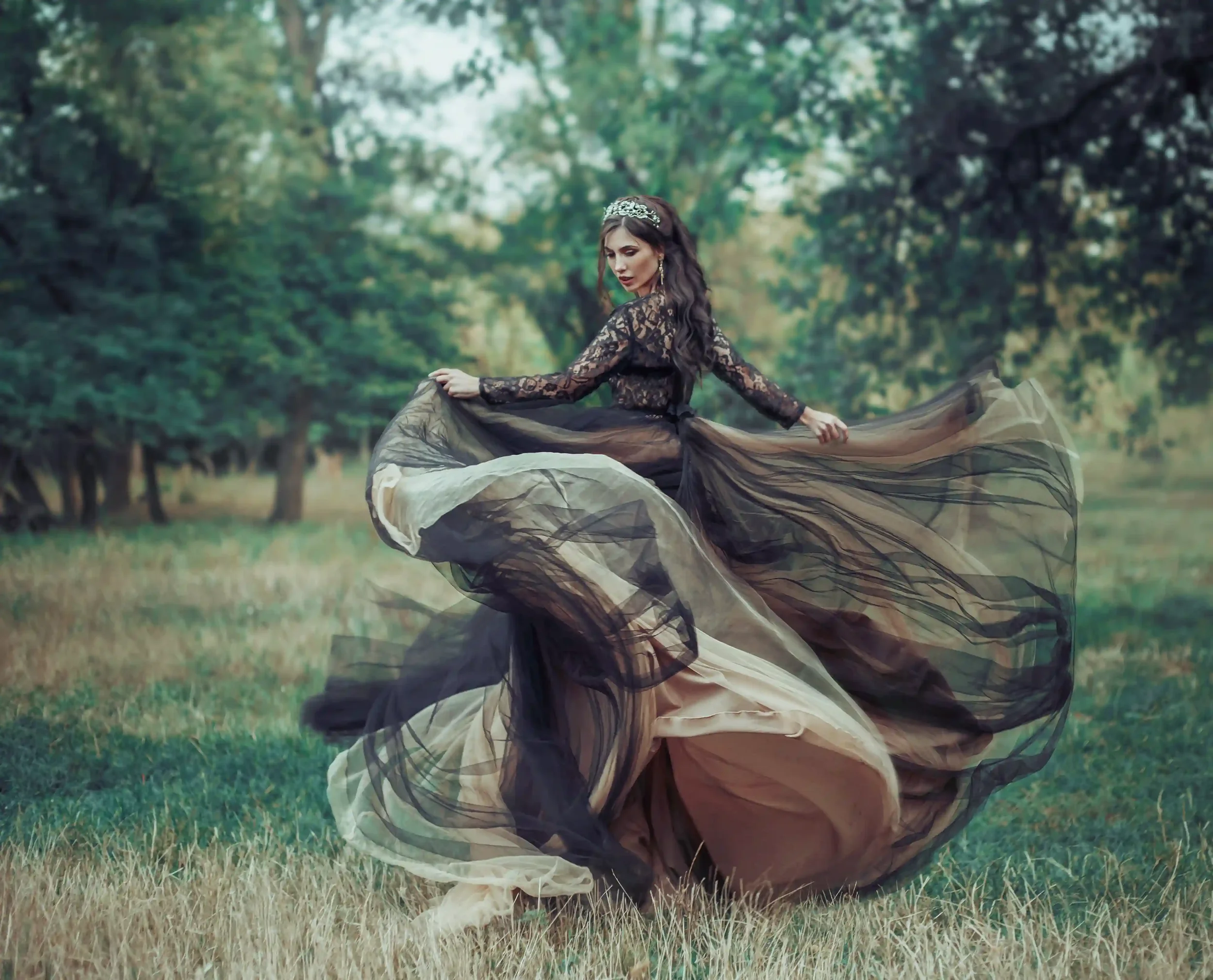 bride in black wedding dress spinning in a field