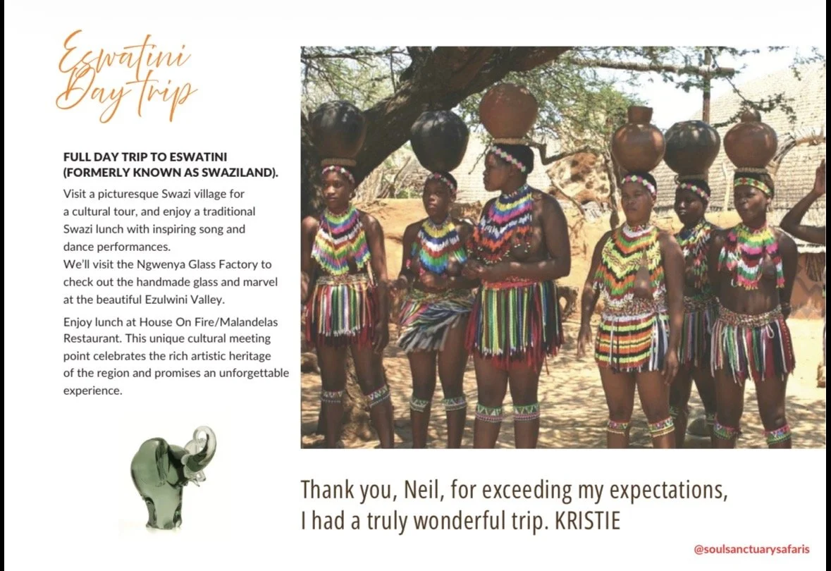 A group of women and girls dressed in traditional colorful Maasai clothing, with beads and jewelry, standing outdoors with trees and pottery vessels balanced on their heads.