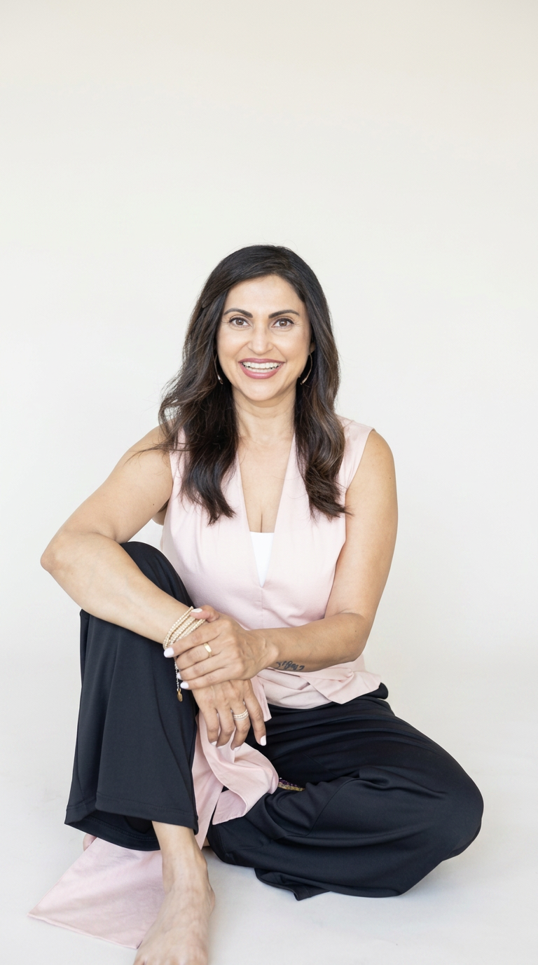 Arzeen Asaria, confidence and mindset coach, seated and smiling