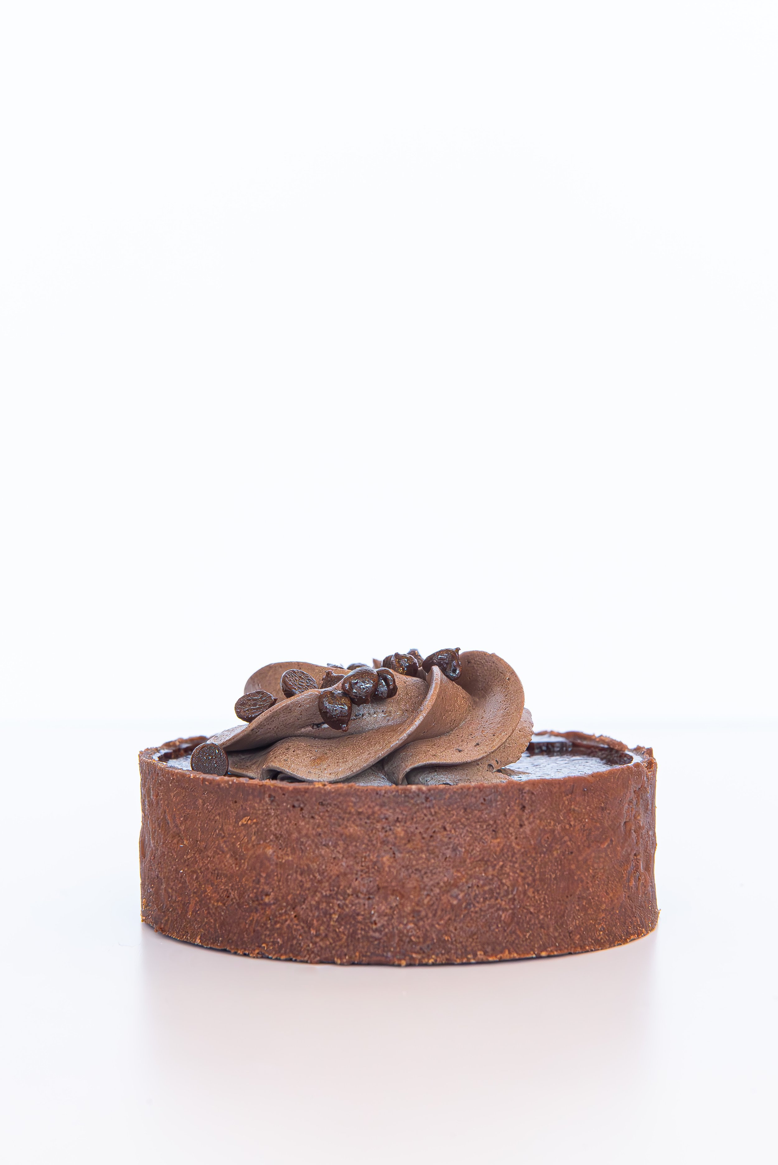 Chocolate tart with chocolate curls and coffee beans on top
