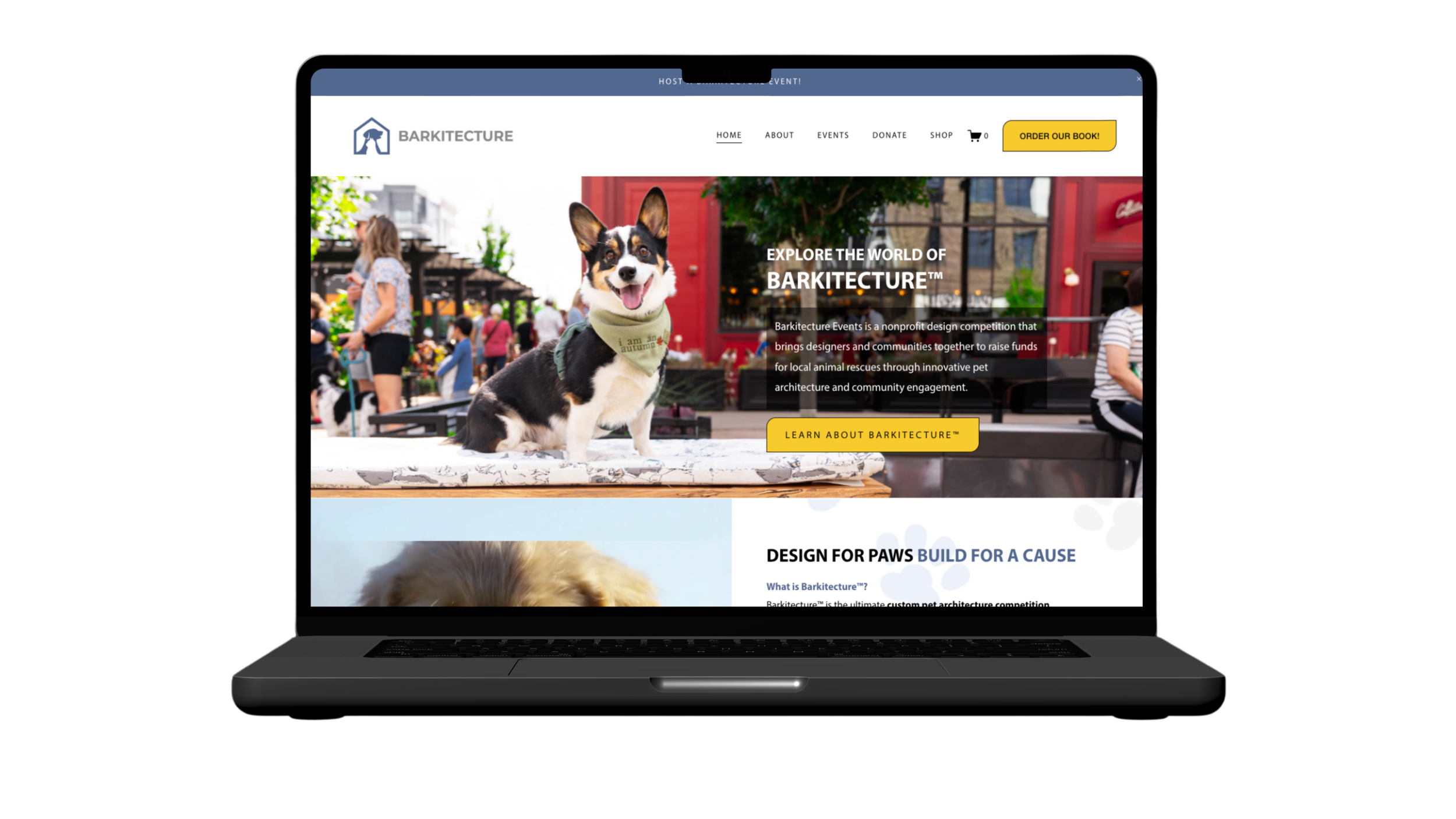 Website homepage for Barkitecture, featuring a happy tricolor dog sitting on a table with people in the background at an outdoor event.