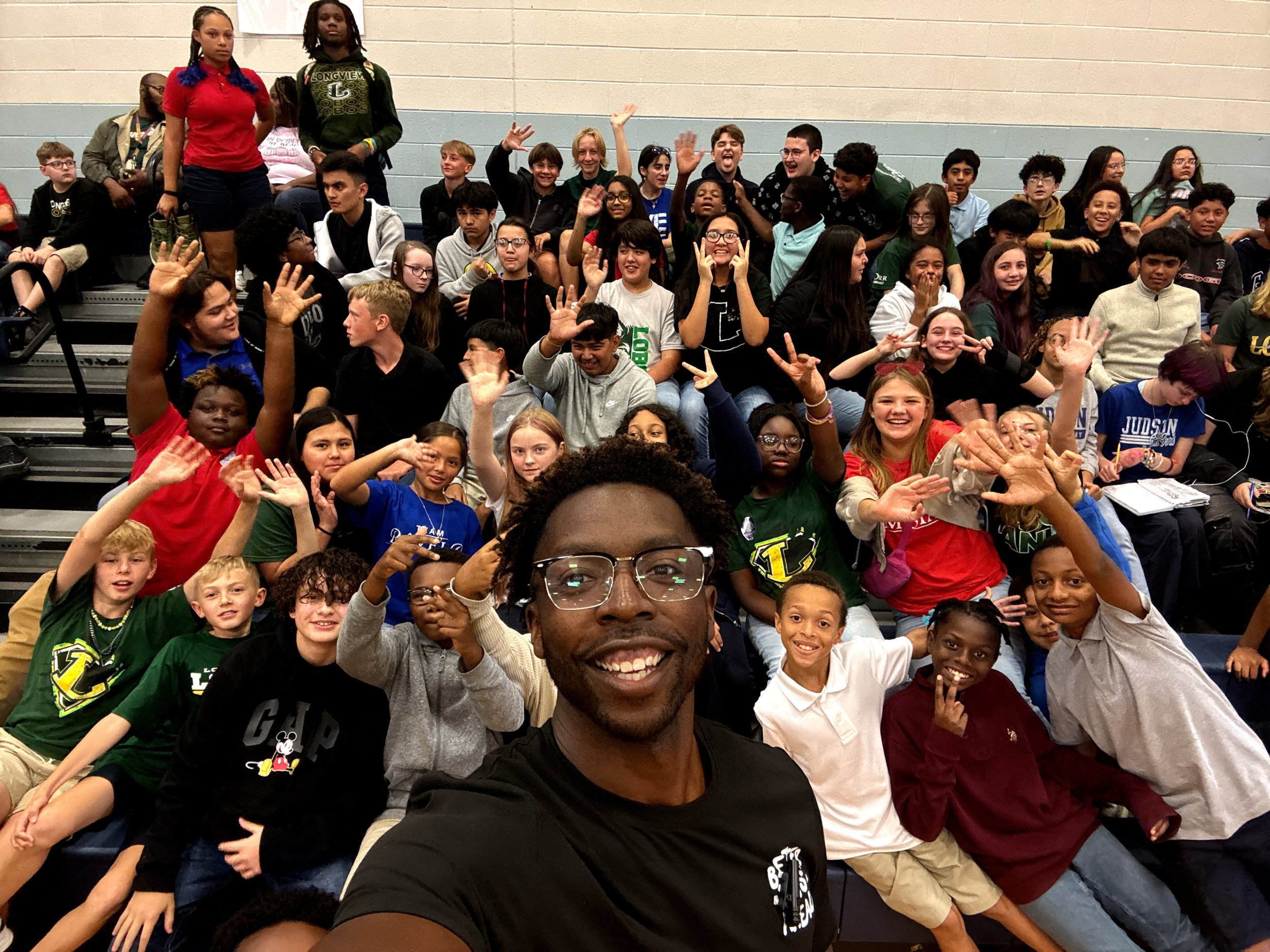 Coach Williams surrounded by students after a student keynote at Judson STEAM Academy