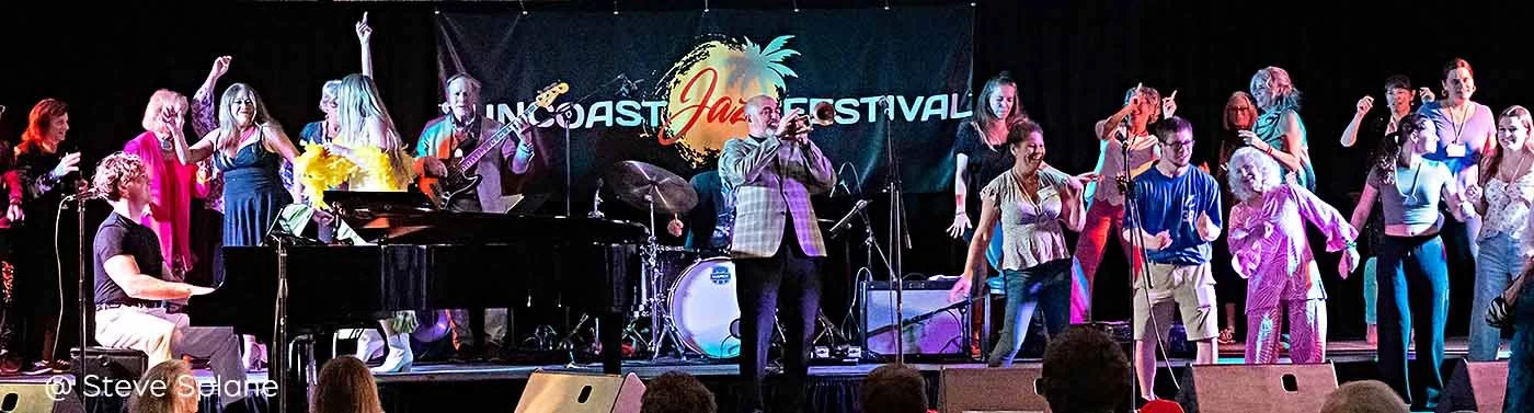 Festival goers dance on stage with the performers at the Suncoast Jazz Festival