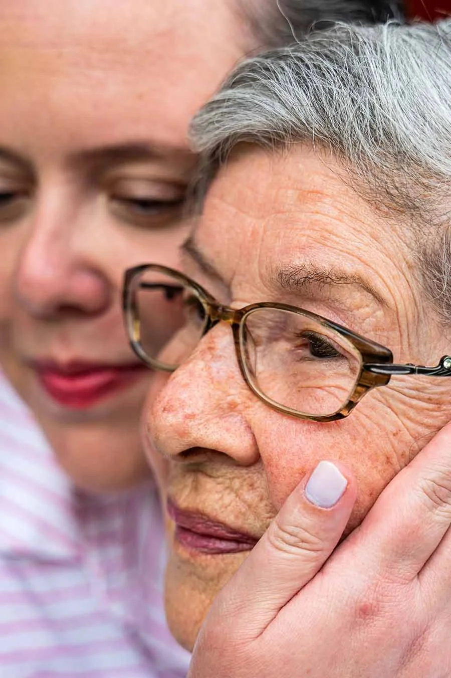 elderly mother and daughter share a.loving moment