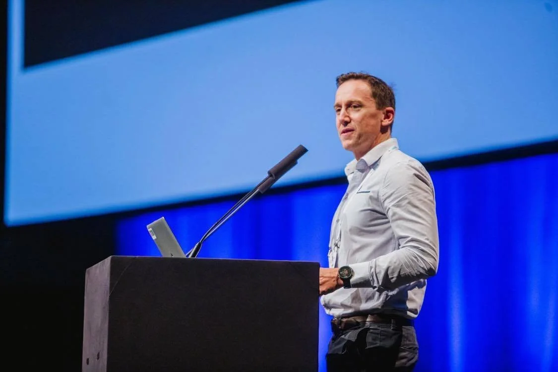 Professor Philip Morgan presenting on a stage