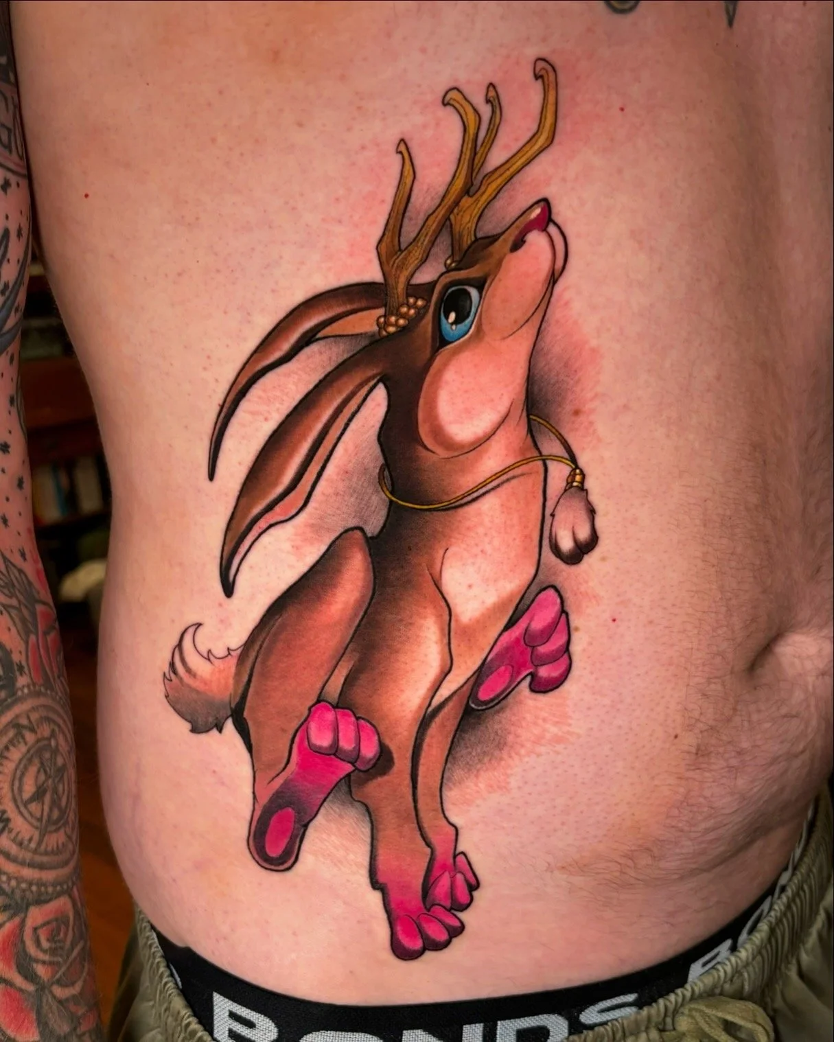 Winged antlered rabbit tattoo on the ribs by Nicklas Wong, tattoo artist in Northcote, Melbourne