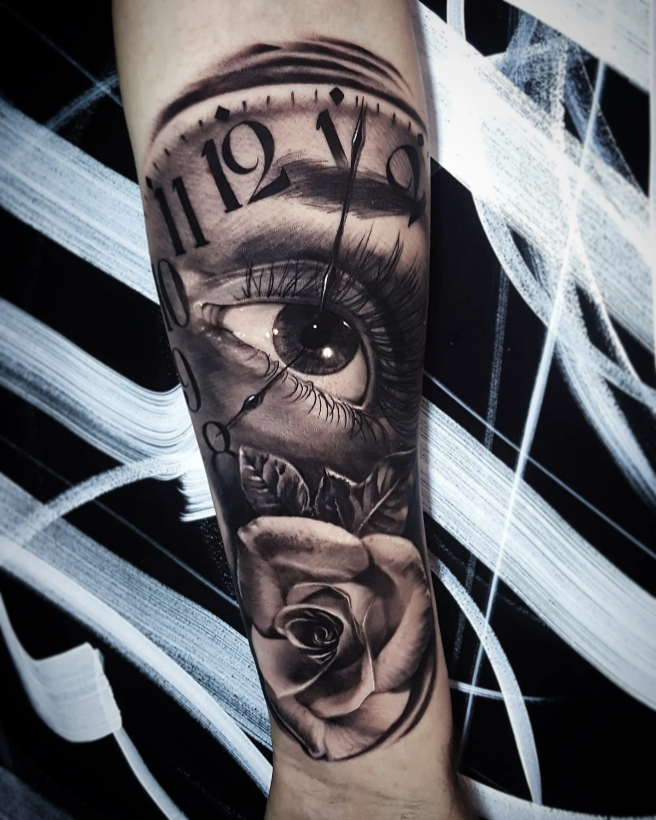 Realistic eye and rose tattoo with Roman numeral details by Nicklas Wong, tattoo artist in Northcote, Melbourne