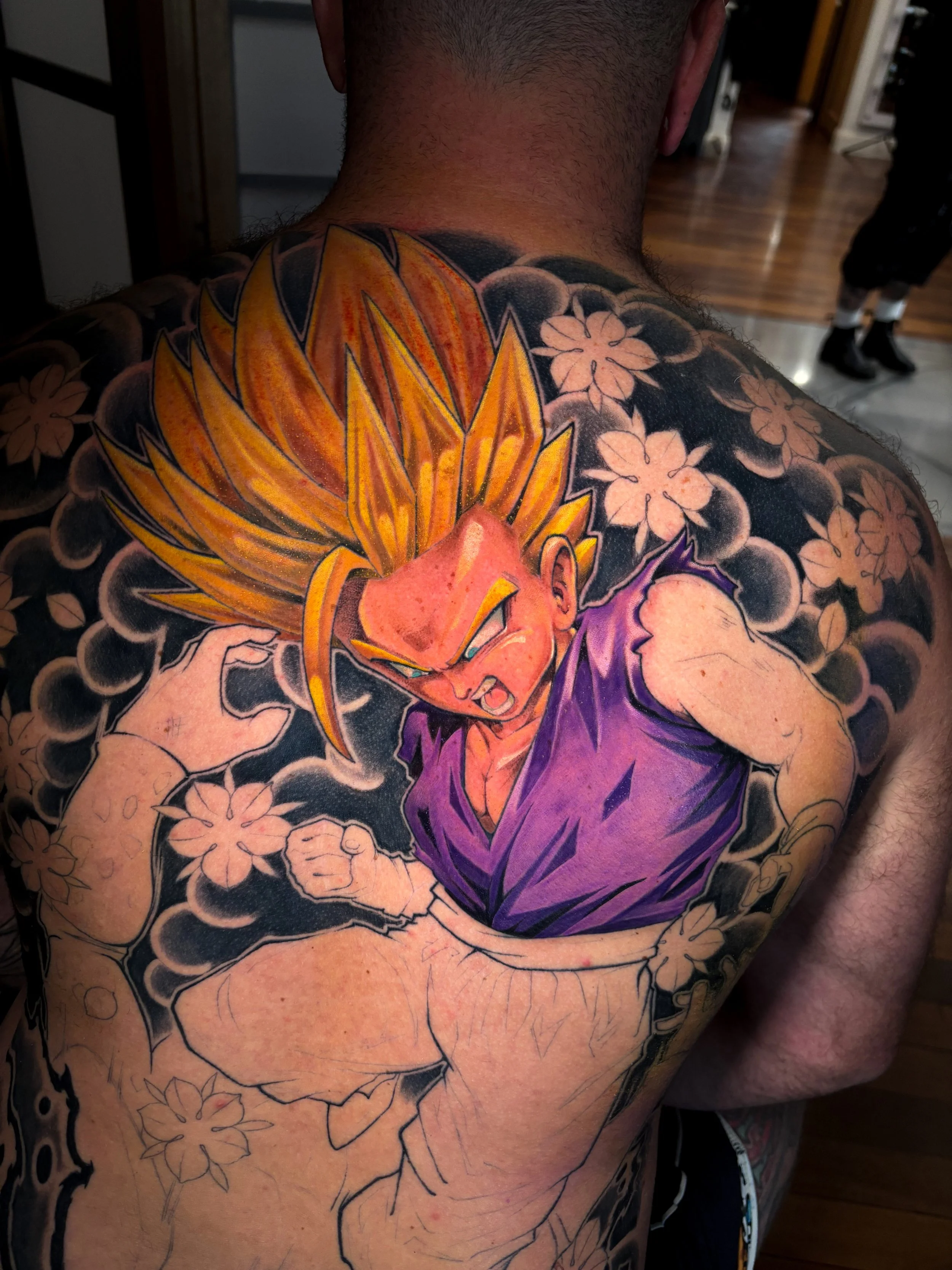 Super Saiyan Gohan backpiece in progress with Japanese-inspired clouds and blossoms by Nicklas Wong, tattoo artist in Northcote, Melbourne