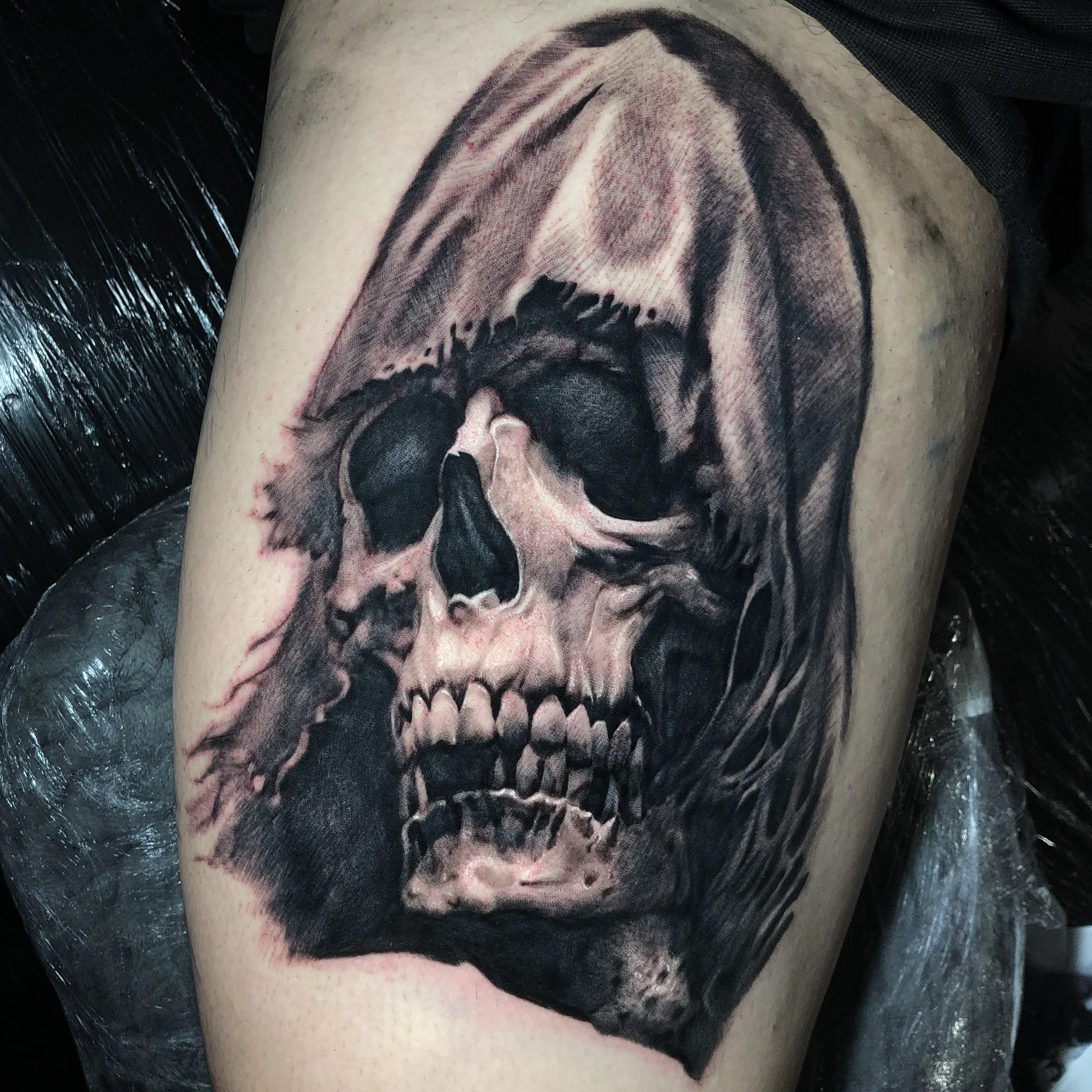 Black and grey skull tattoo with deep shadows by Nicklas Wong, tattoo artist in Northcote, Melbourne