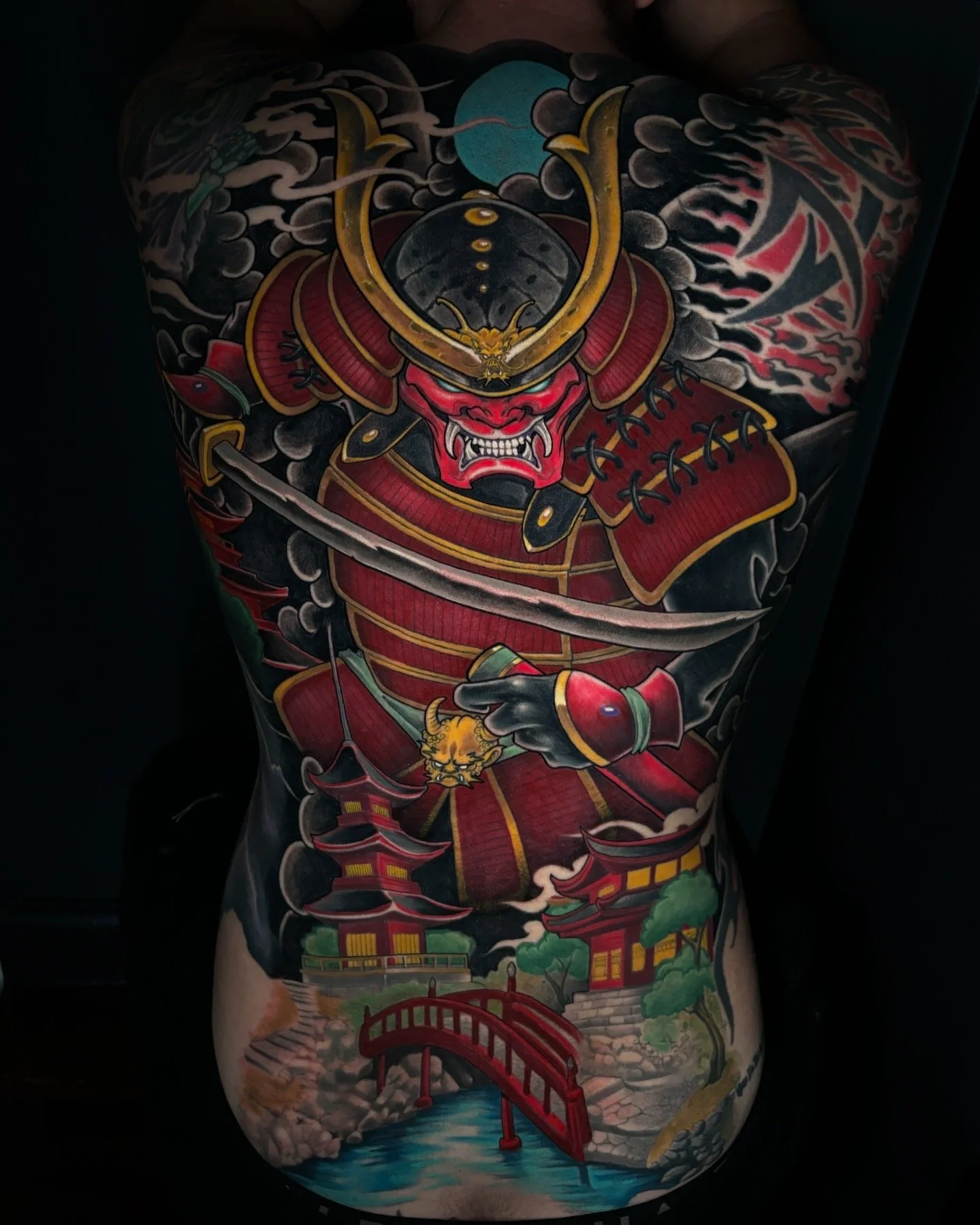 Full back tattoo of a samurai in red armour with a Japanese landscape by Nicklas Wong, tattoo artist in Northcote, Melbourne