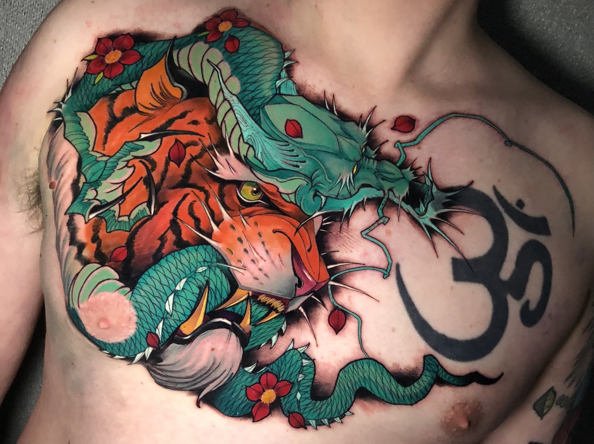 Japanese dragon and tiger chest tattoo in green and orange by Nicklas Wong, tattoo artist in Northcote, Melbourne