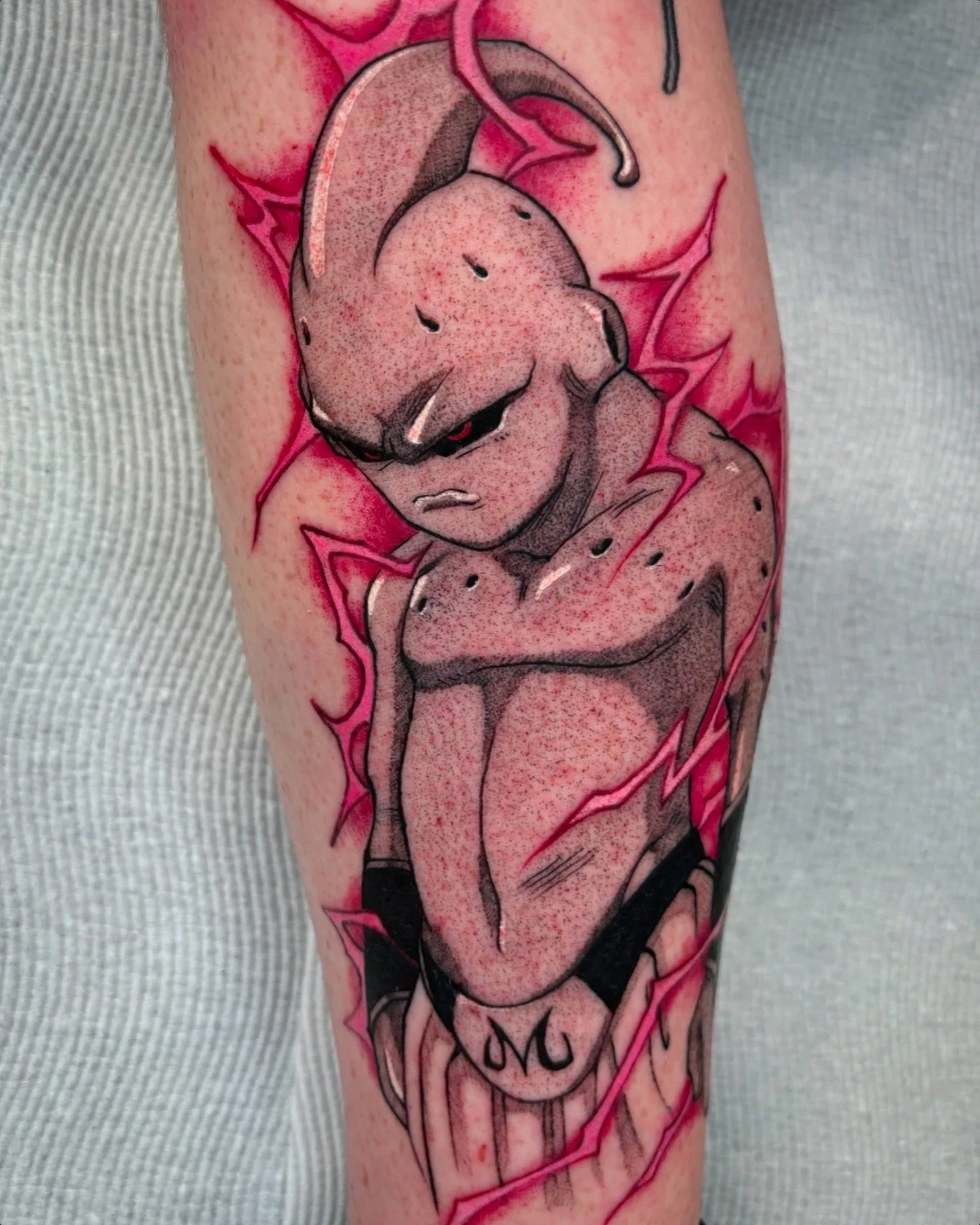 Majin Buu character tattoo with pink energy effects by Nicklas Wong, tattoo artist in Northcote, Melbourne