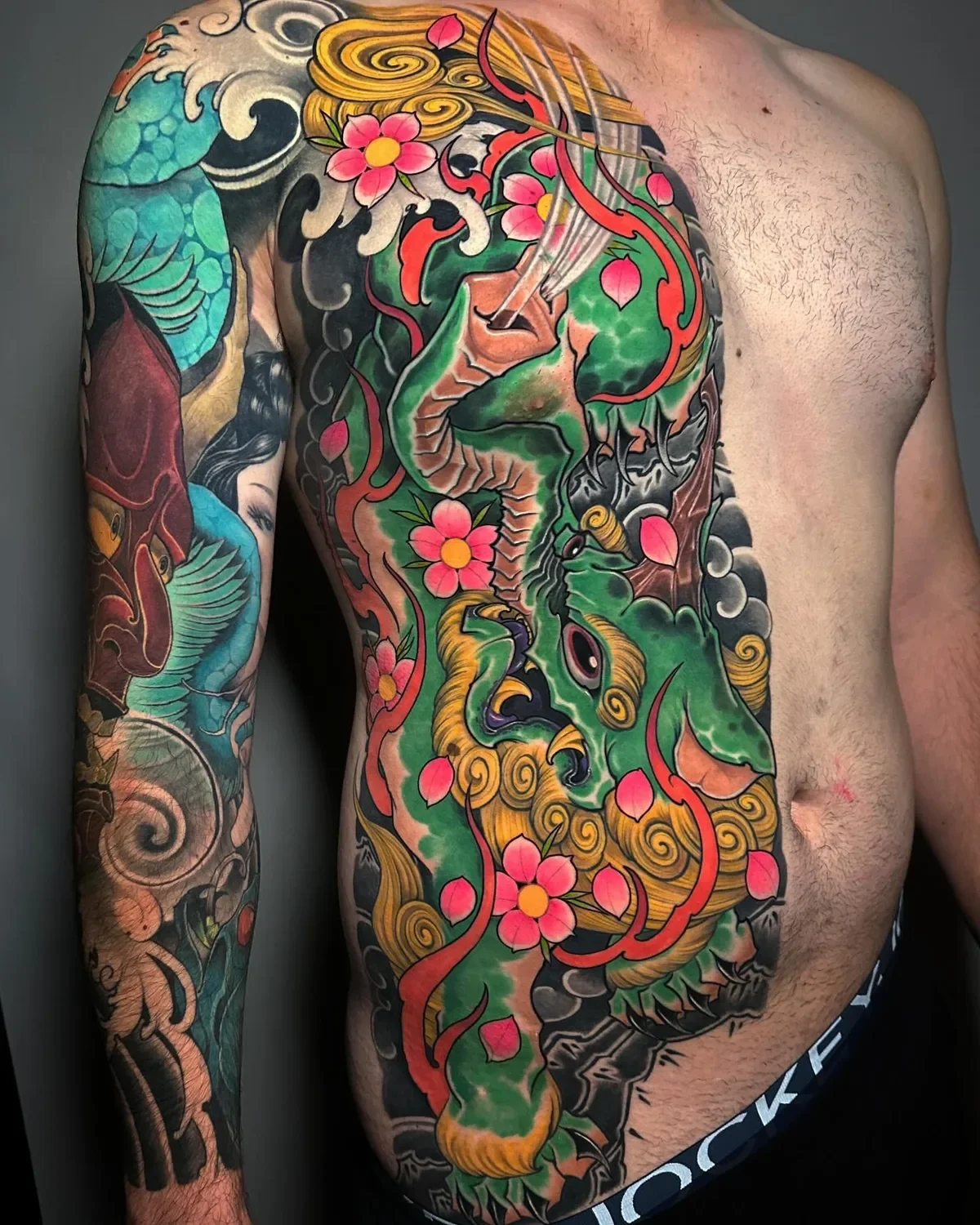 Colourful neo-Japanese guardian tattoo across the chest and torso by Nicklas Wong, tattoo artist in Northcote, Melbourne