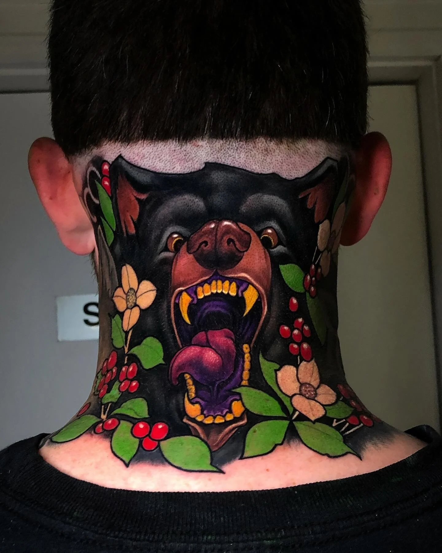 Neo-traditional roaring big cat tattoo across the back of the neck by Nicklas Wong, tattoo artist in Northcote, Melbourne