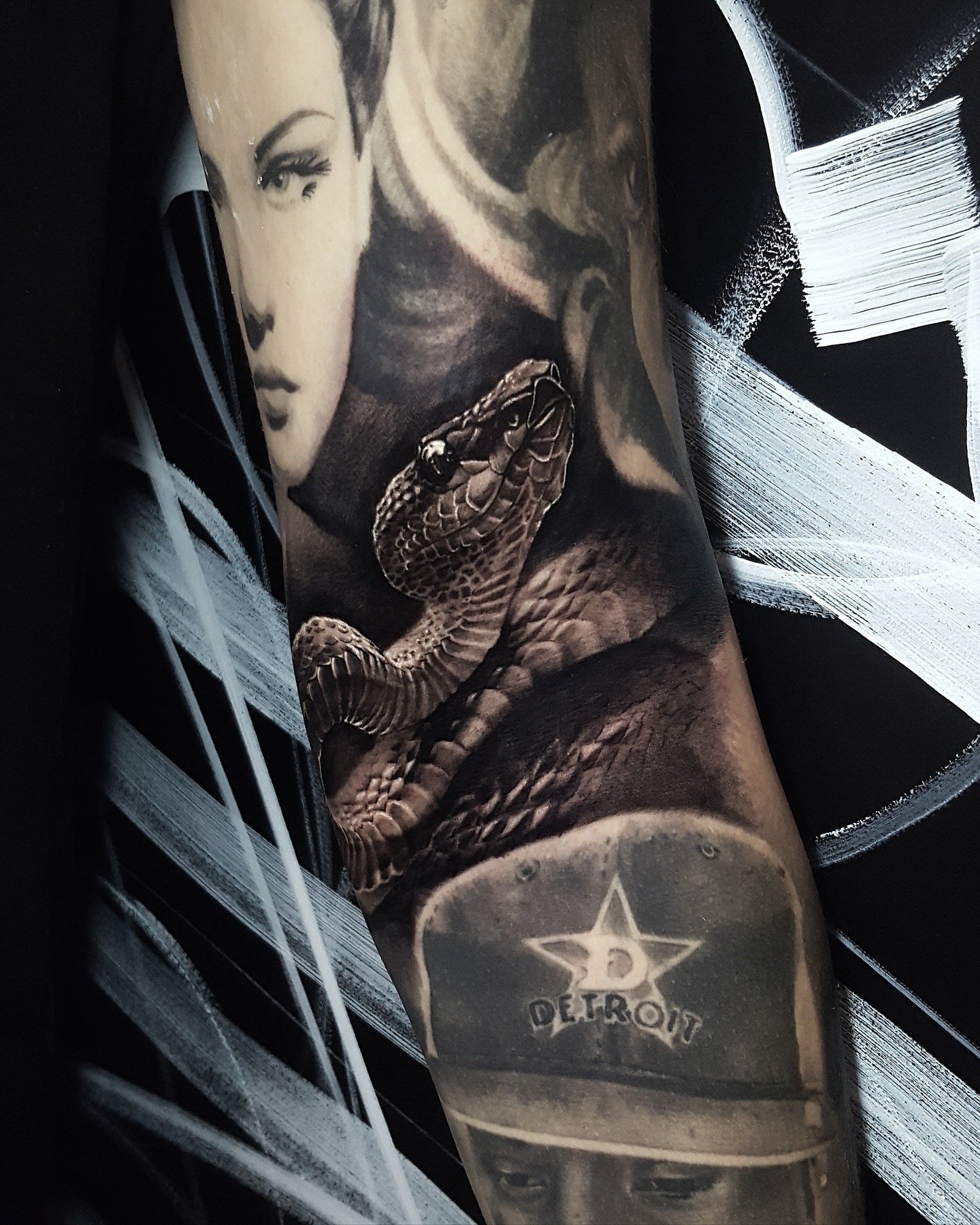 Black and grey sleeve detail with portraits and a realistic snake by Nicklas Wong, tattoo artist in Northcote, Melbourne