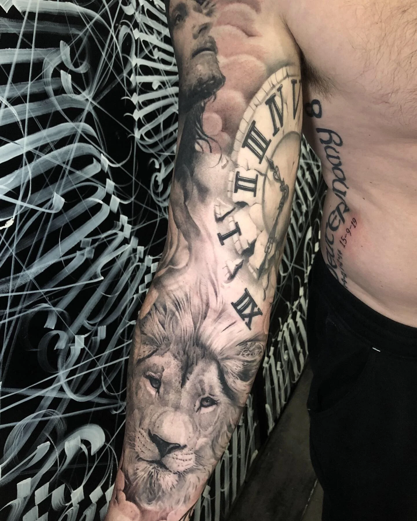 Black and grey realism sleeve with a lion and Roman numeral clock by Nicklas Wong, tattoo artist in Northcote, Melbourne