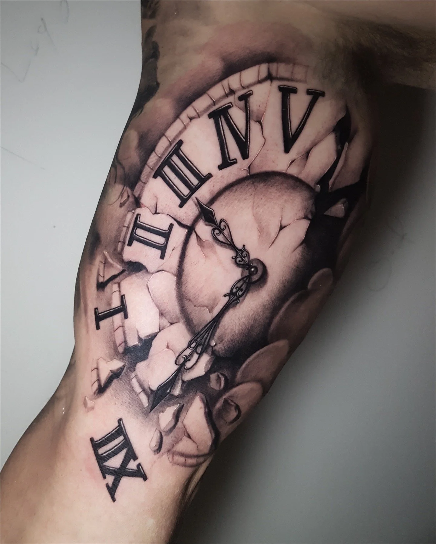 Black and grey clock tattoo with Roman numerals by Nicklas Wong, tattoo artist in Northcote, Melbourne