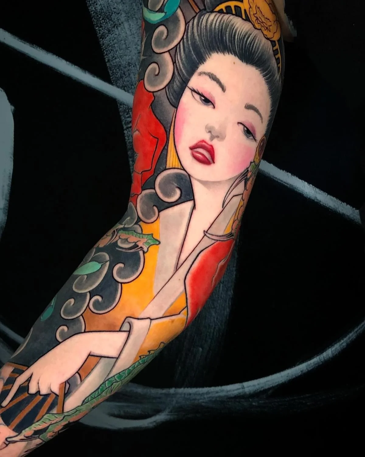 Japanese-inspired woman portrait and clouds on a forearm by Nicklas Wong, tattoo artist in Northcote, Melbourne