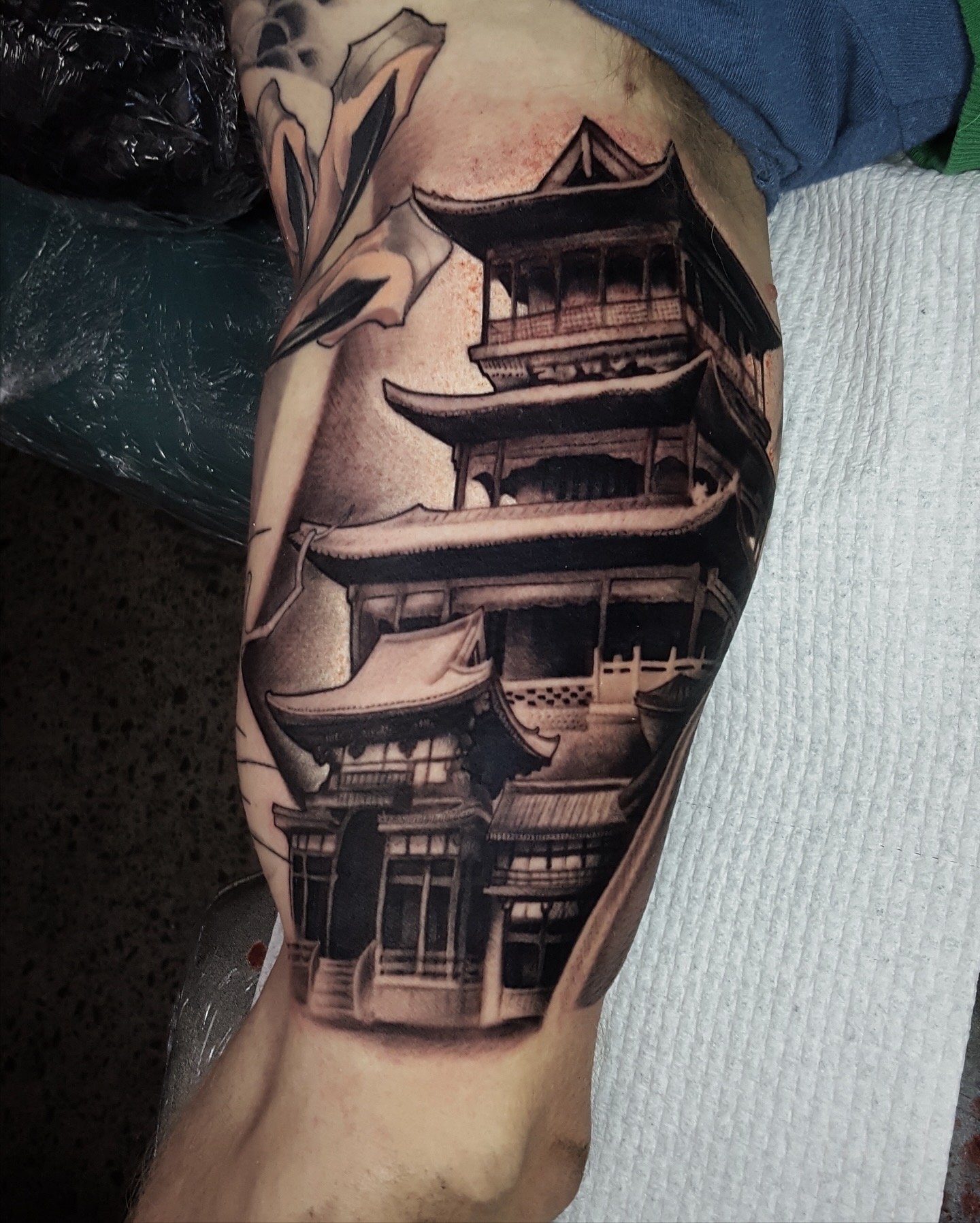 Black and grey Japanese pagoda tattoo with detailed architecture by Nicklas Wong, tattoo artist in Northcote, Melbourne