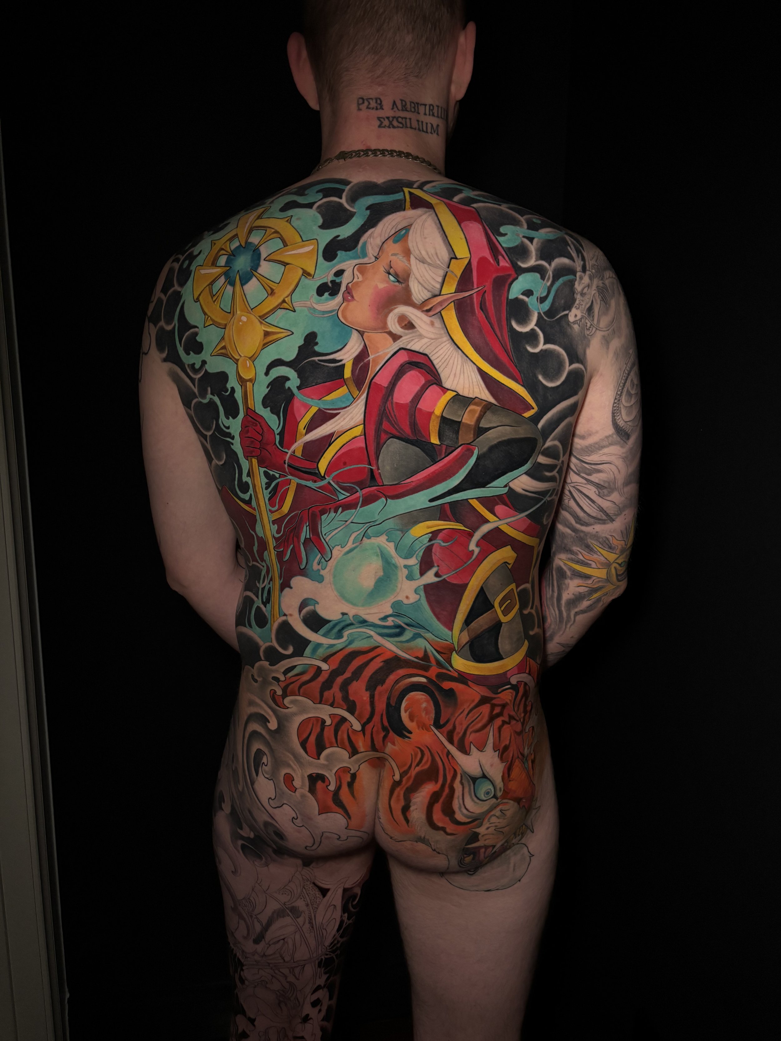 Colour fantasy backpiece with an elven character, staff and Japanese-inspired clouds by Nicklas Wong, tattoo artist in Northcote, Melbourne
