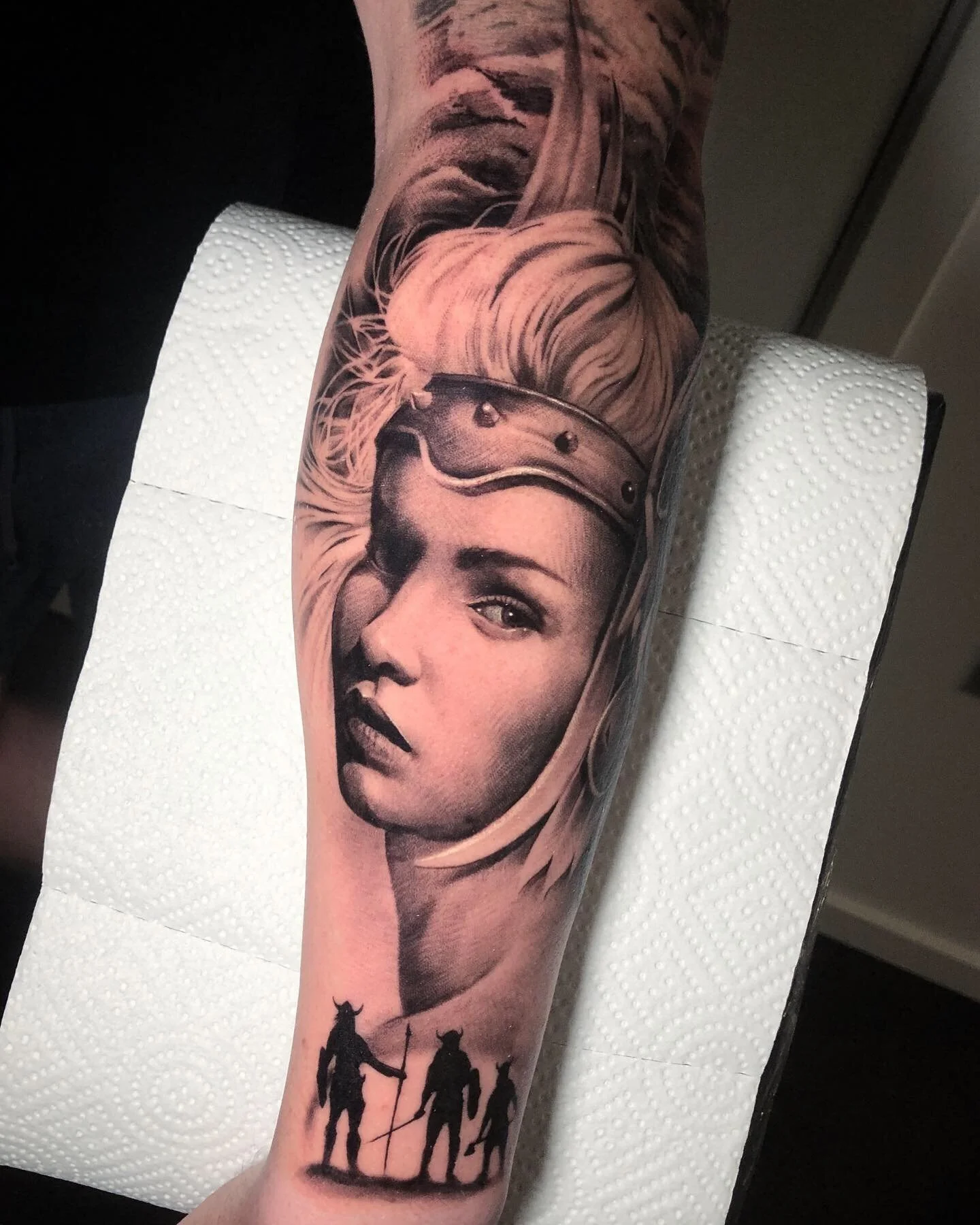 Black and grey woman portrait tattoo with small silhouettes below by Nicklas Wong, tattoo artist in Northcote, Melbourne