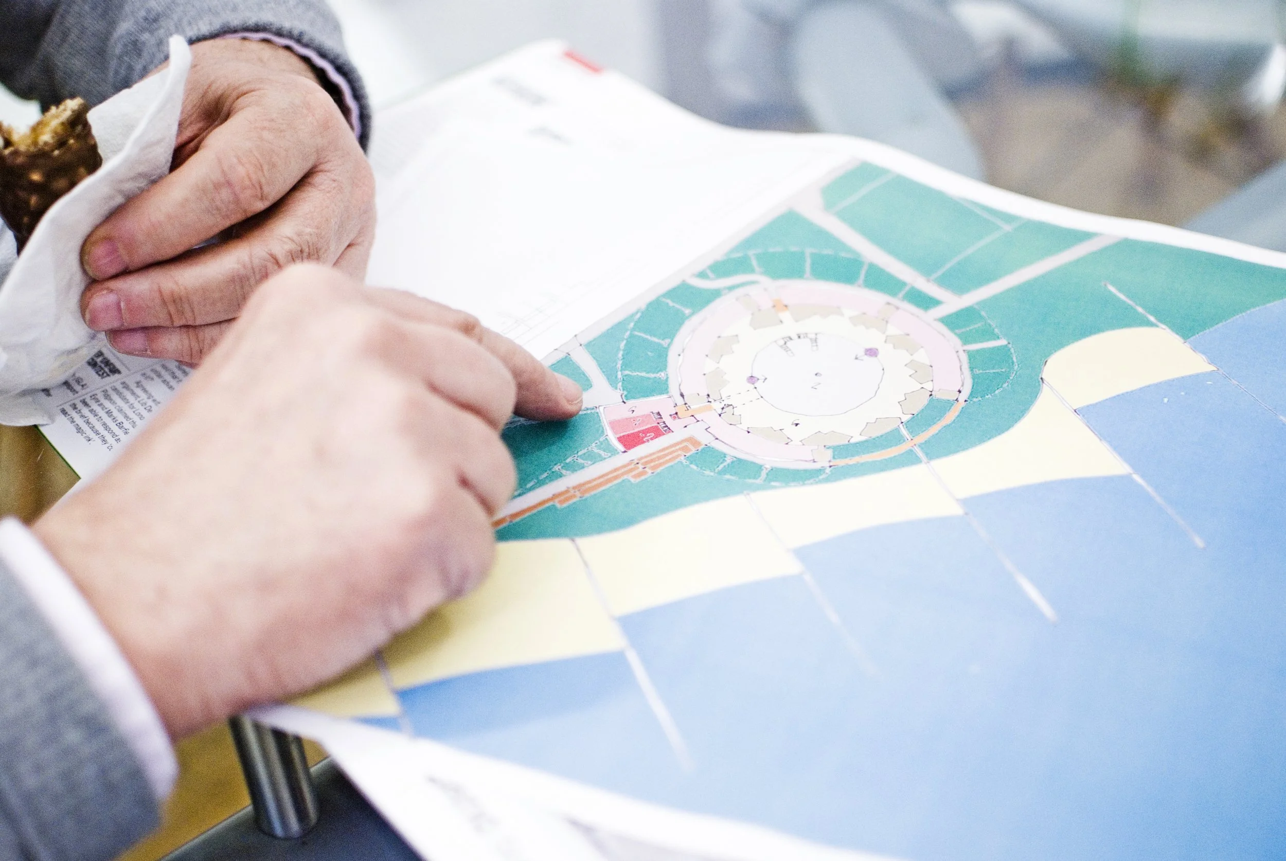 a hand pointing at a drawings