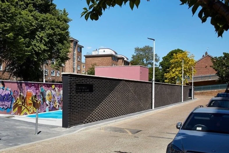 texture brick walls contain the space and Spanish steps provide access down into the ball court from street level