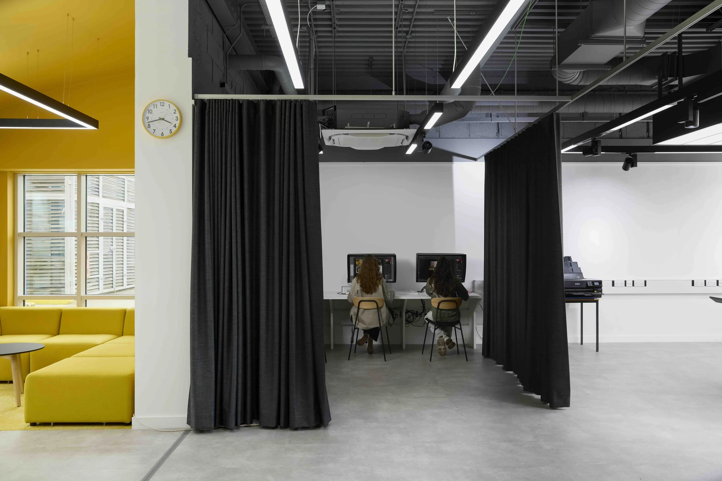 Rock Townsend Architects LLP — The Photographic Studio, Harrow Campus, University Of Westminster - Two women seated at desks working on desktop computers, separated from the public