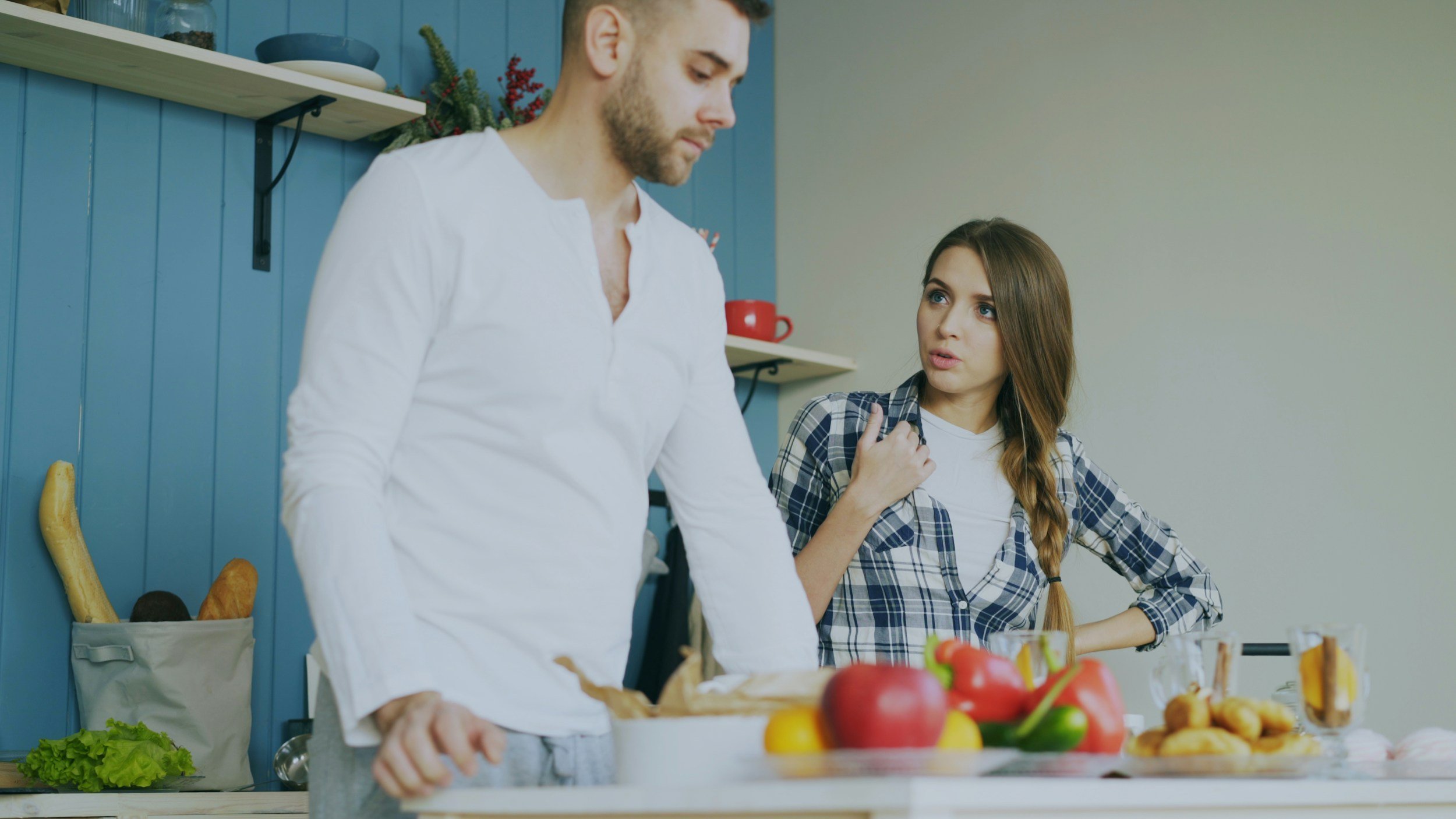 Couple arguing in kitchen — how emotional abandonment creates conflict and communication breakdown in adult relationships, therapy Inese Jegorova UK