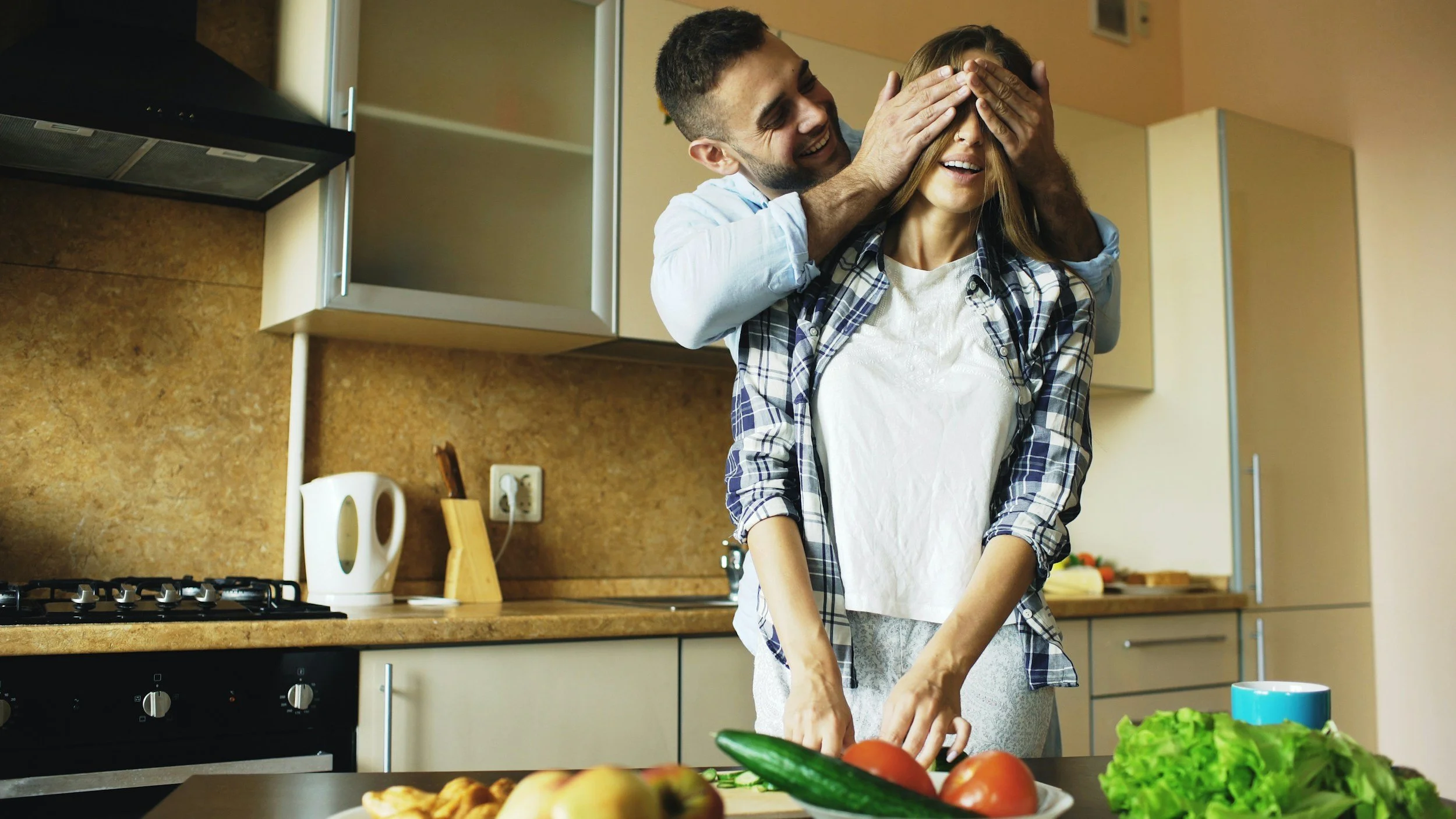 Couple sharing playful moment of joy and trust — healing emotional abandonment and building secure attachment through online therapy Inese Jegorova UK
