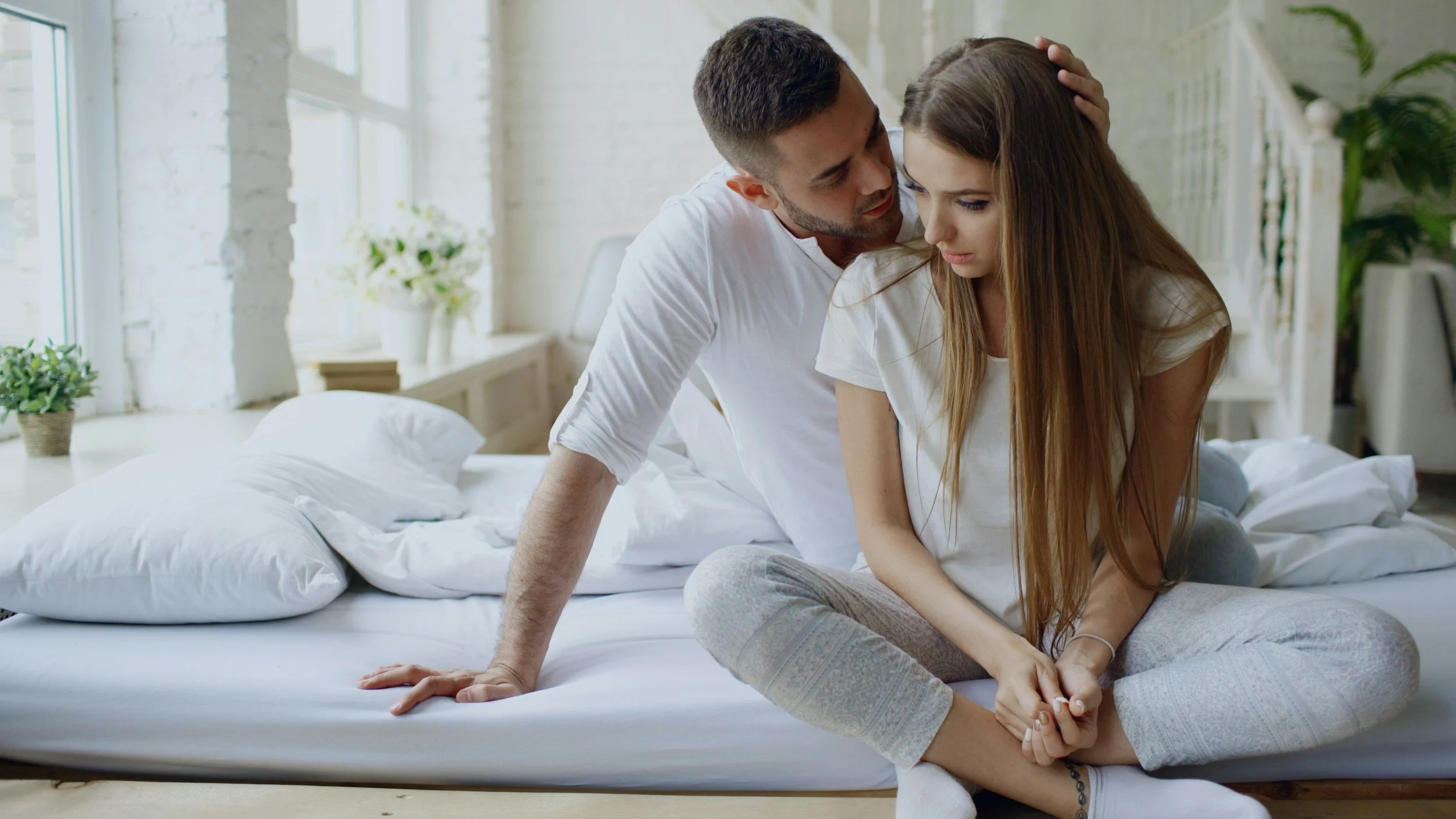 Man comforting partner — mutual emotional support and secure connection after healing emotional abandonment, online psychotherapy Inese Jegorova UK