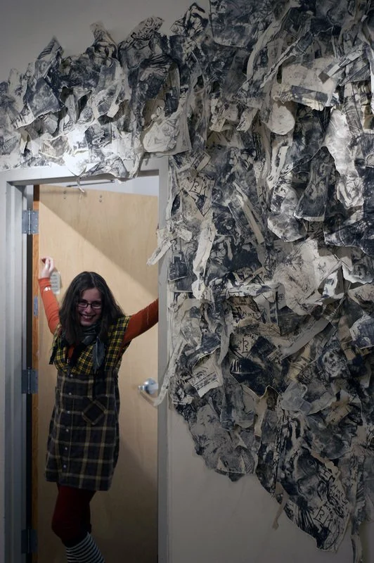 The artist underneath her Welcome Home VAE installation, 2009, stone lithographs and thread