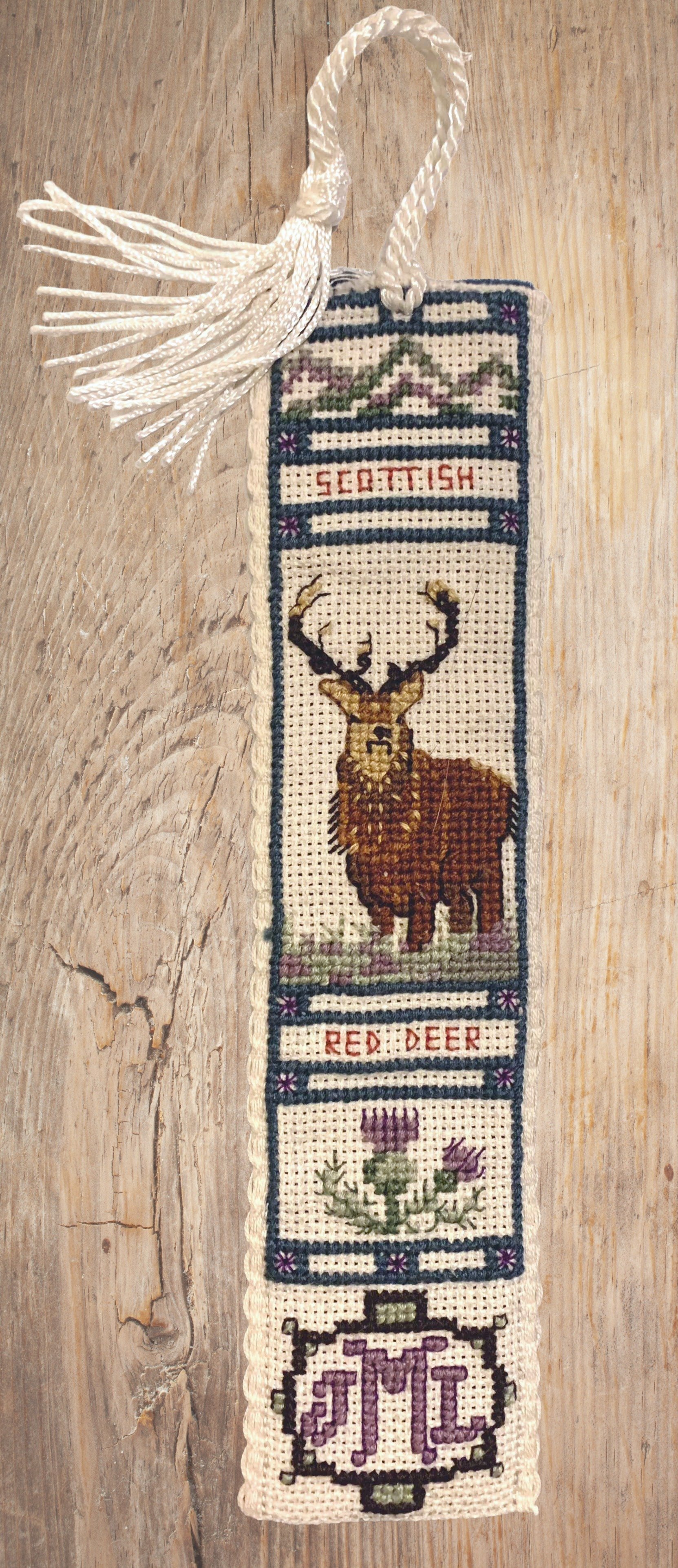 Red Deer Monogrammed Bookmark, 2021, cotton thread on aida with polyester tassel and felt backing.