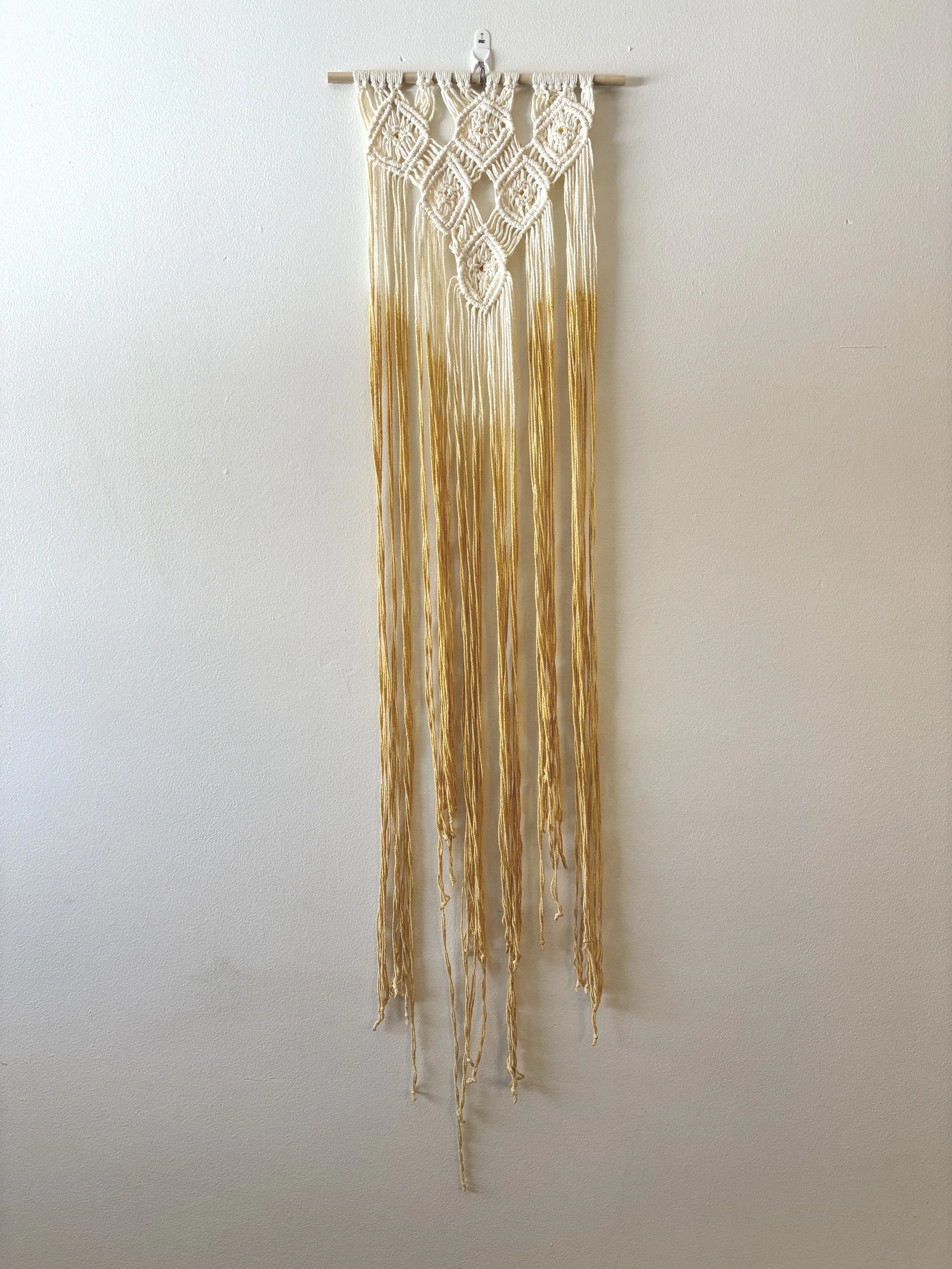 Diamonds Wall Hanging, 2025, hand turmeric dyed cotton yarn and wooden dowel. 