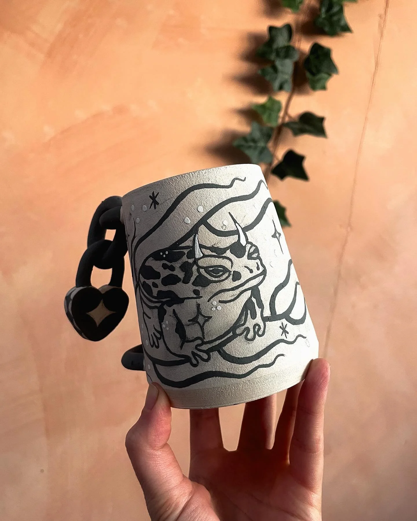Spent the evening painting a padlock mug I made with a toad, he&rsquo;s a lil messy with pencil but he&rsquo;ll be completely transformed once he&rsquo;s had his glaze and been through the kiln 🐸 can&rsquo;t wait to see him finished! 
#frogmug #tatt