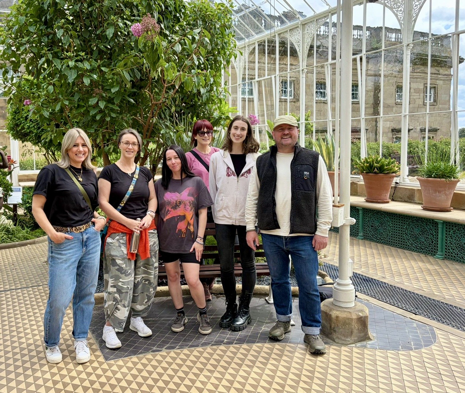 Kindred Footing group photo of 6 adults standing in a glass house at Wentworth Castle Gardens