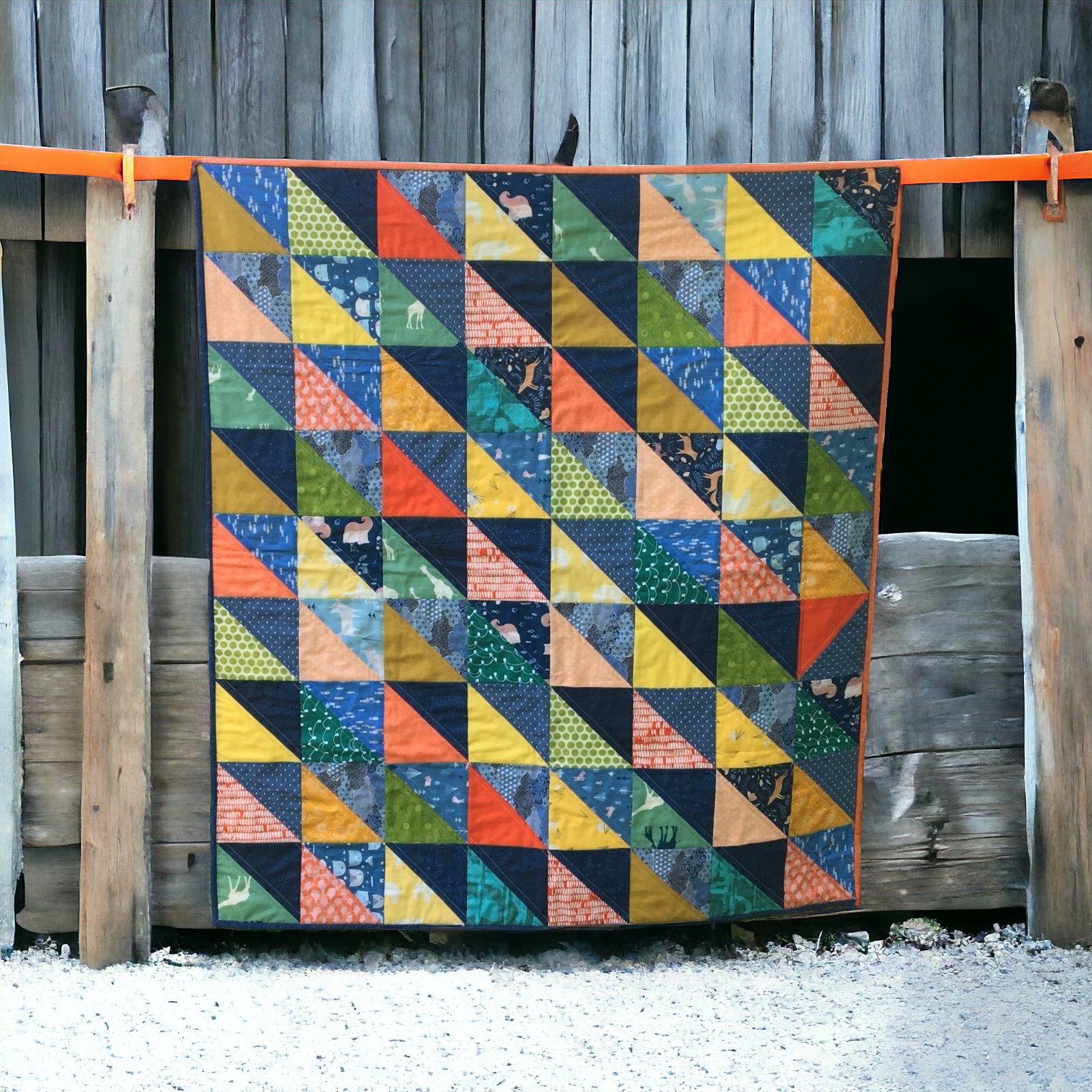 This half-square triangle quilt was made with colors used in Baby Felix's nursery.
