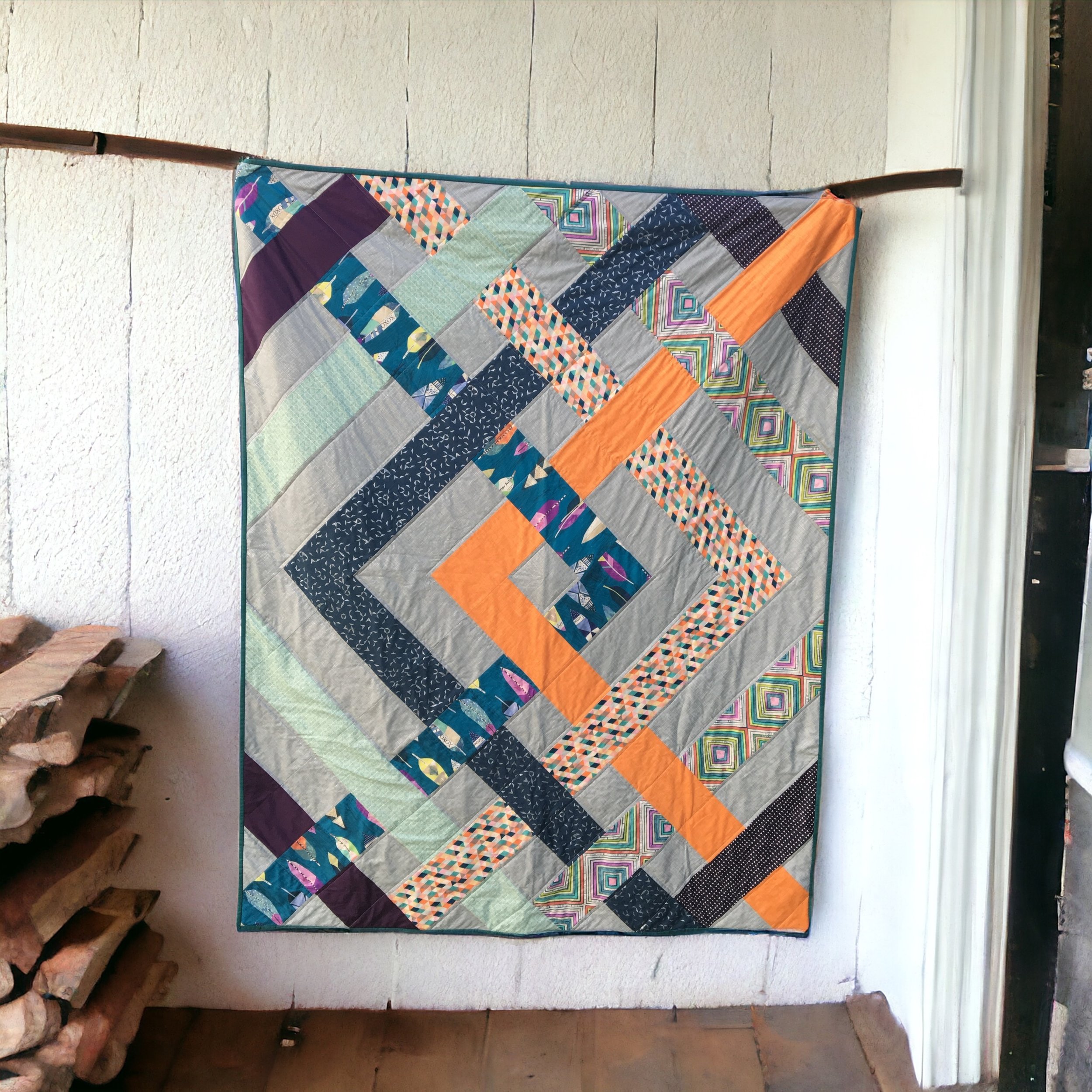 A wedding quilt of lines intersecting using the client's color preferences (pattern is The Eliza Quilt by Kitchen Table Quilting)