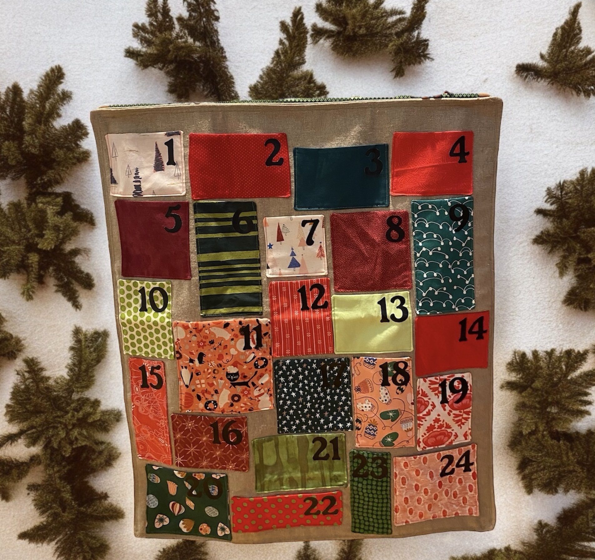 A wall hanging with various pocket sizes for treasures or notes during the Advent season