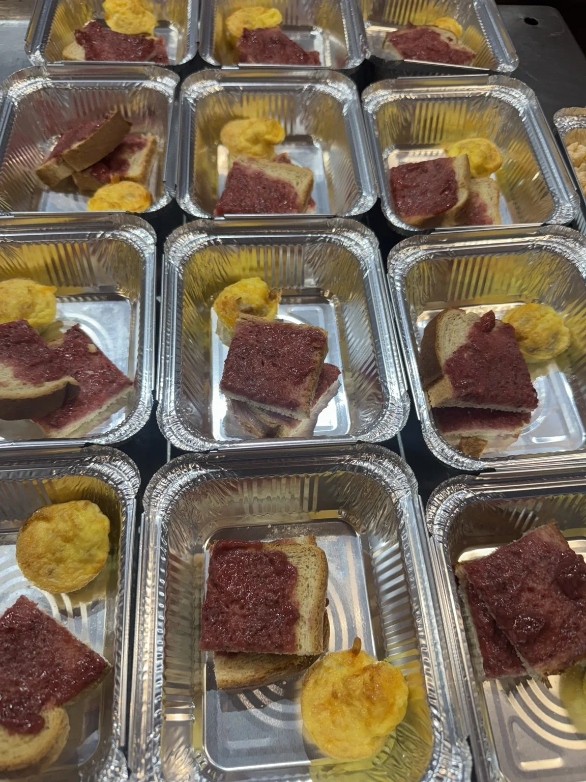 Breakfast trays with toast, fruit spread and egg bites.