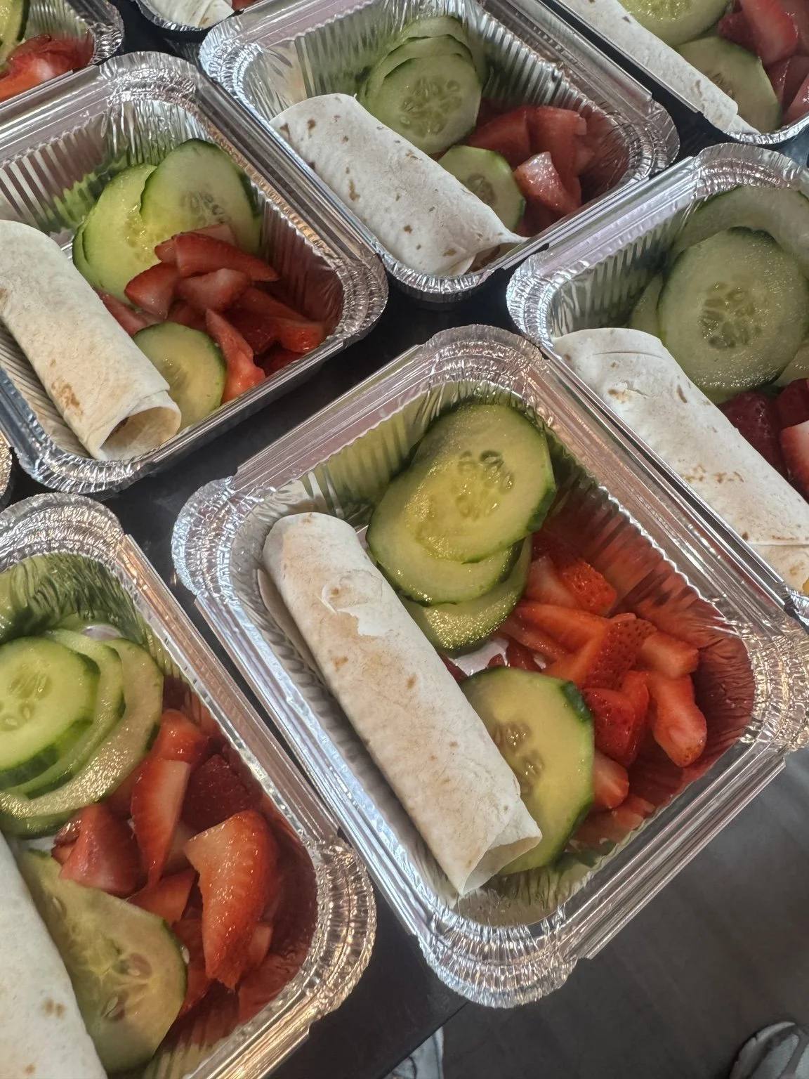Wrap meals with cucumber and strawberries prepared by Socialized Catering