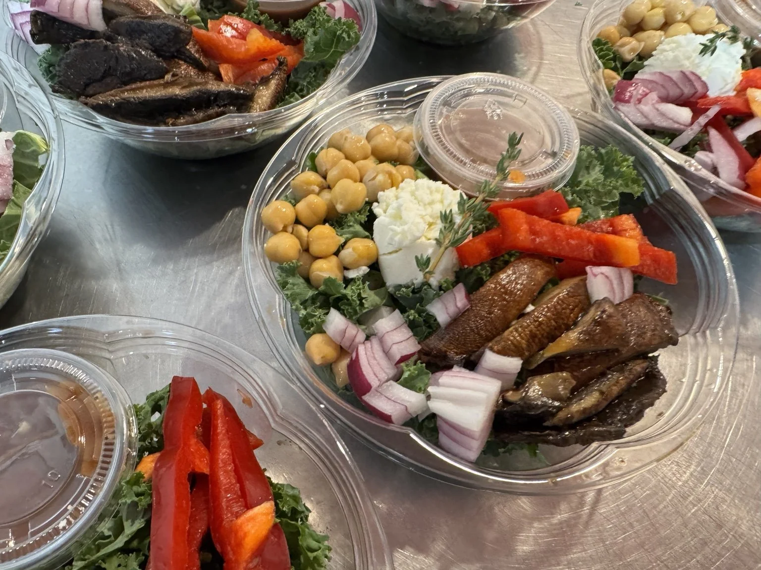 Mushroom and chickpea bowls with greens, peppers and dressing on the side.