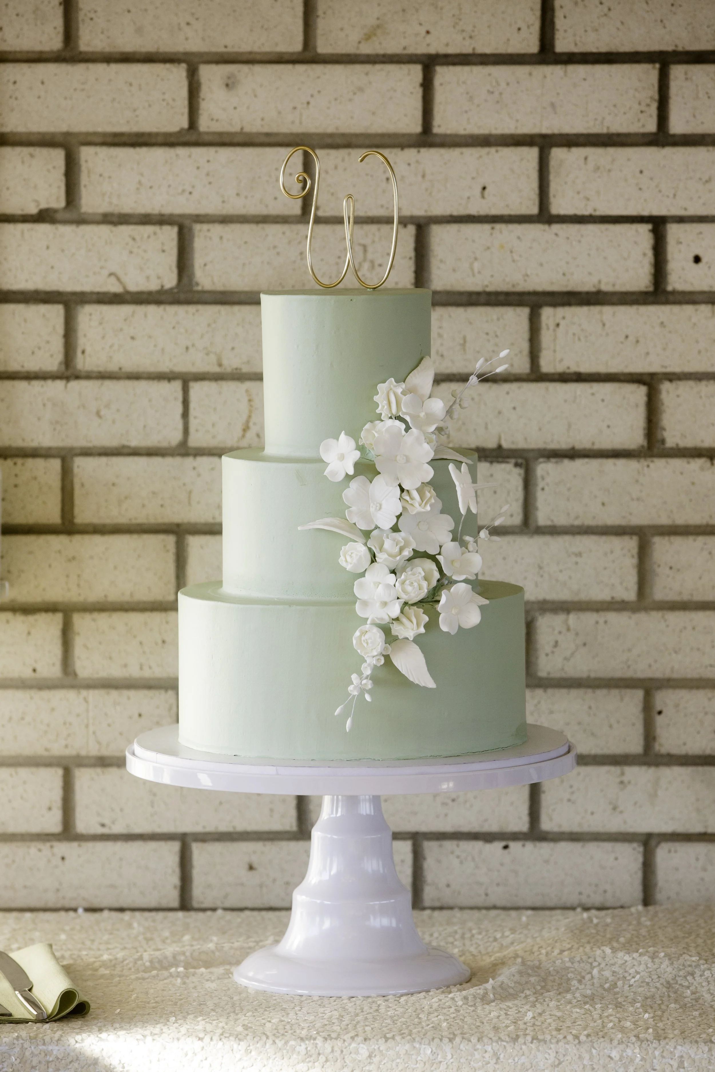 Three tier sage green wedding cake with amazing floral detail