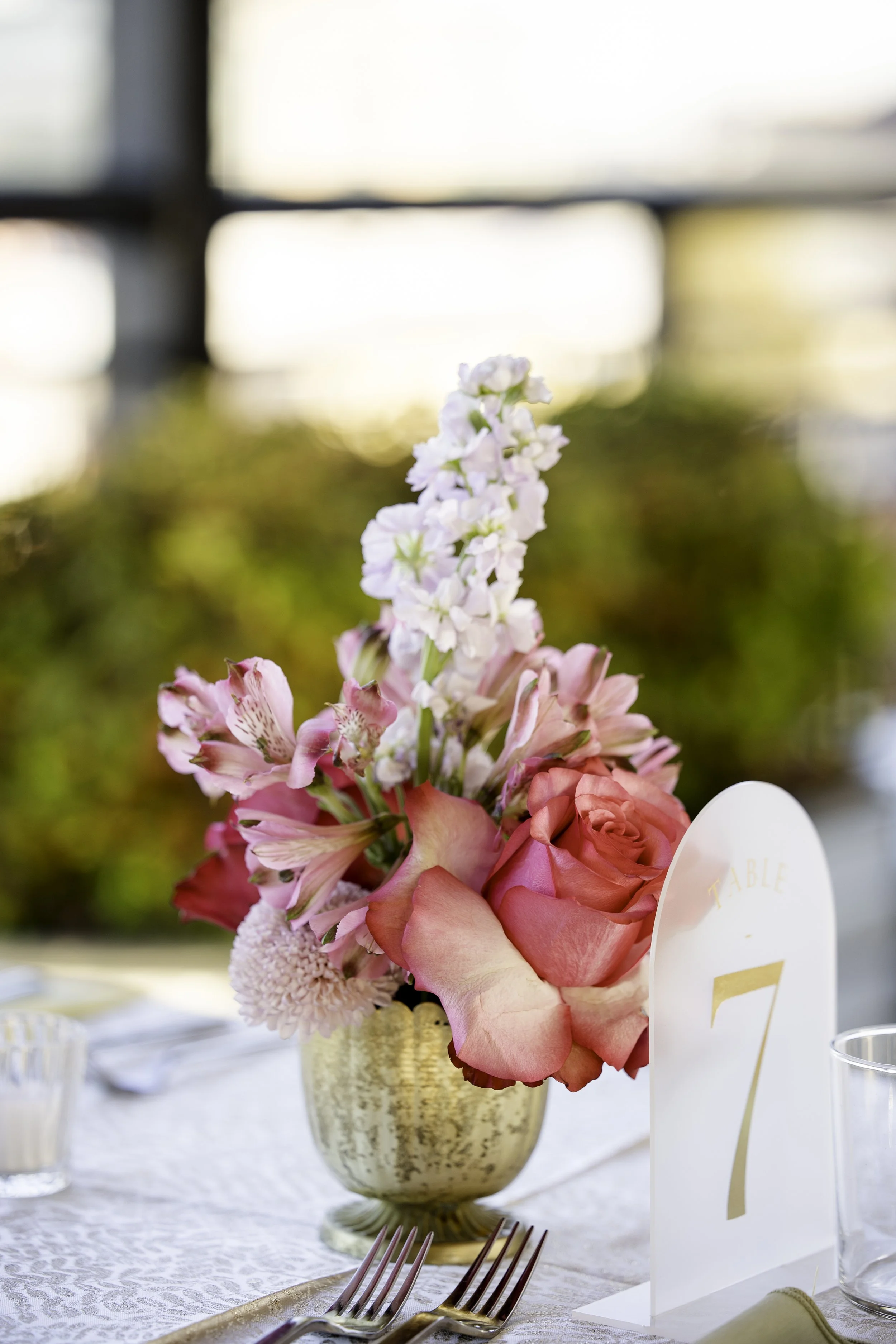 Beautiful Florals on guest table with gold linens