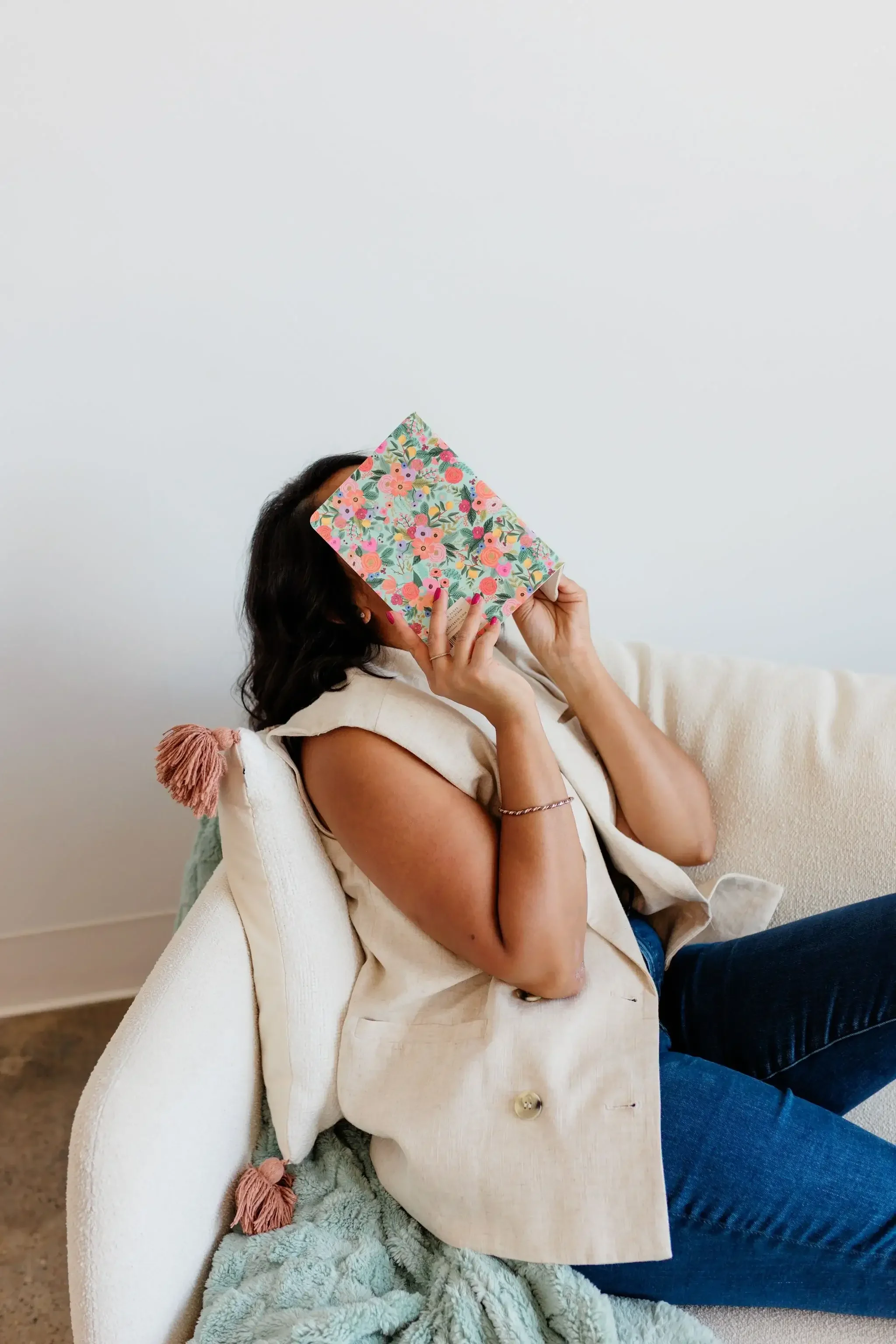 Image of Priyanka Rao holding a book+while+seated+-+ADHD Coach  Asha Coaching&Consulting