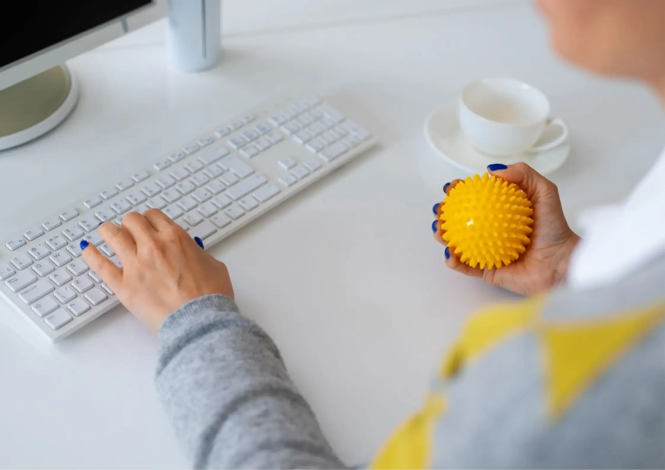 A woman using a stress ball to help her focus - Asha Coaching & Consulting