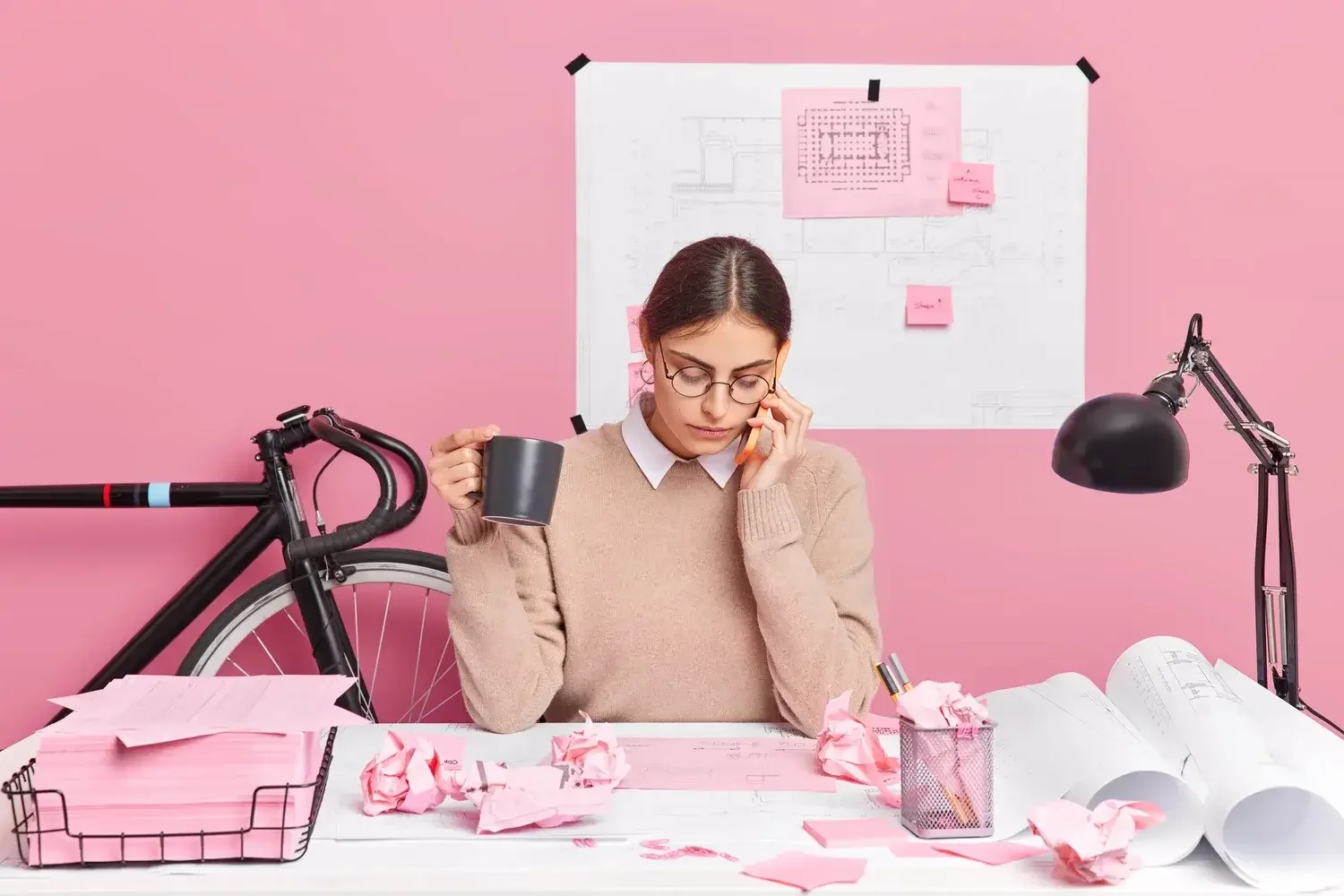 A woman on her desk who is struggling to organize things because of her ADHD - Asha Coaching & Consulting