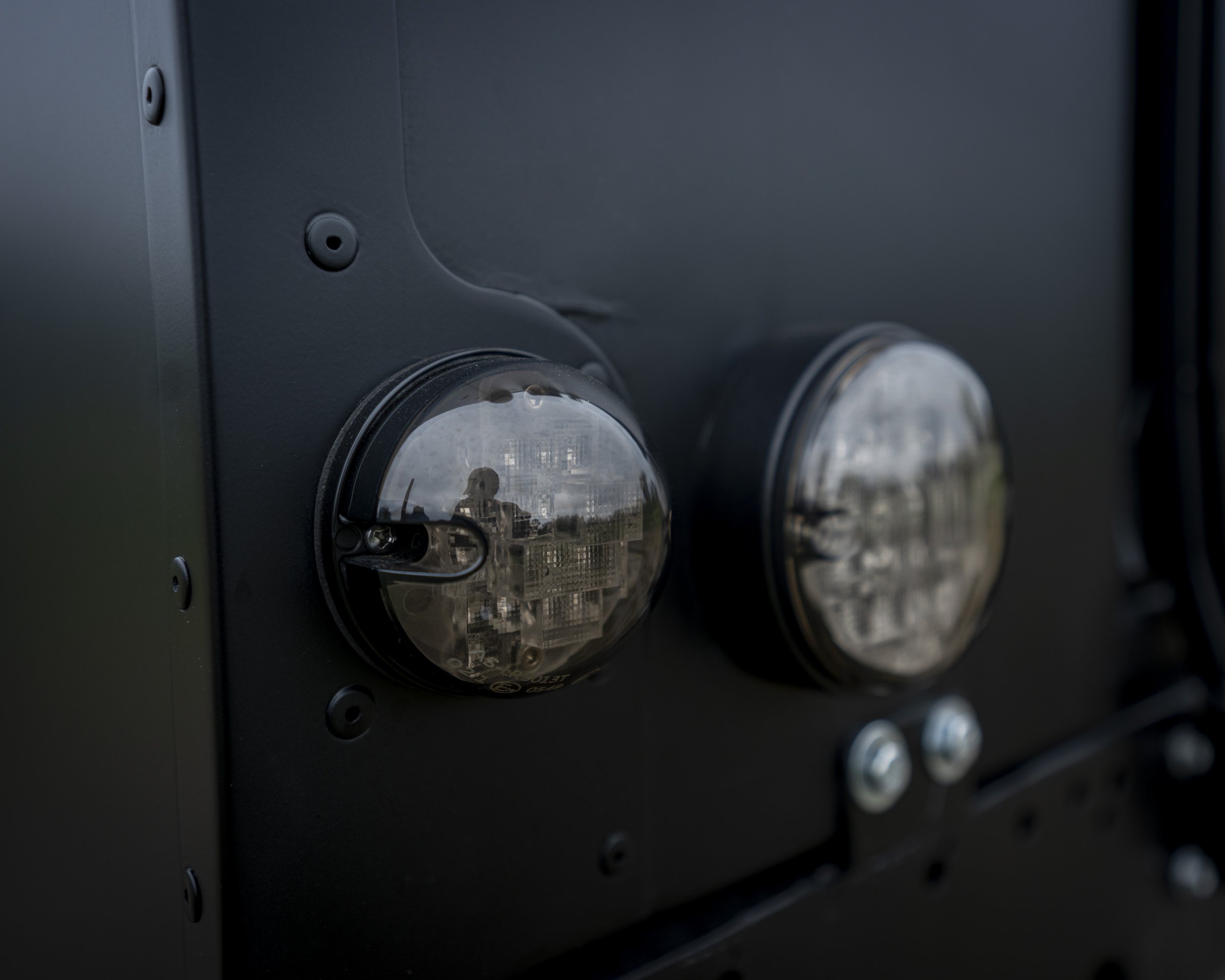 Close-up of an electronic device with two circular transparent components, possibly sensors or cameras, mounted on a black panel.